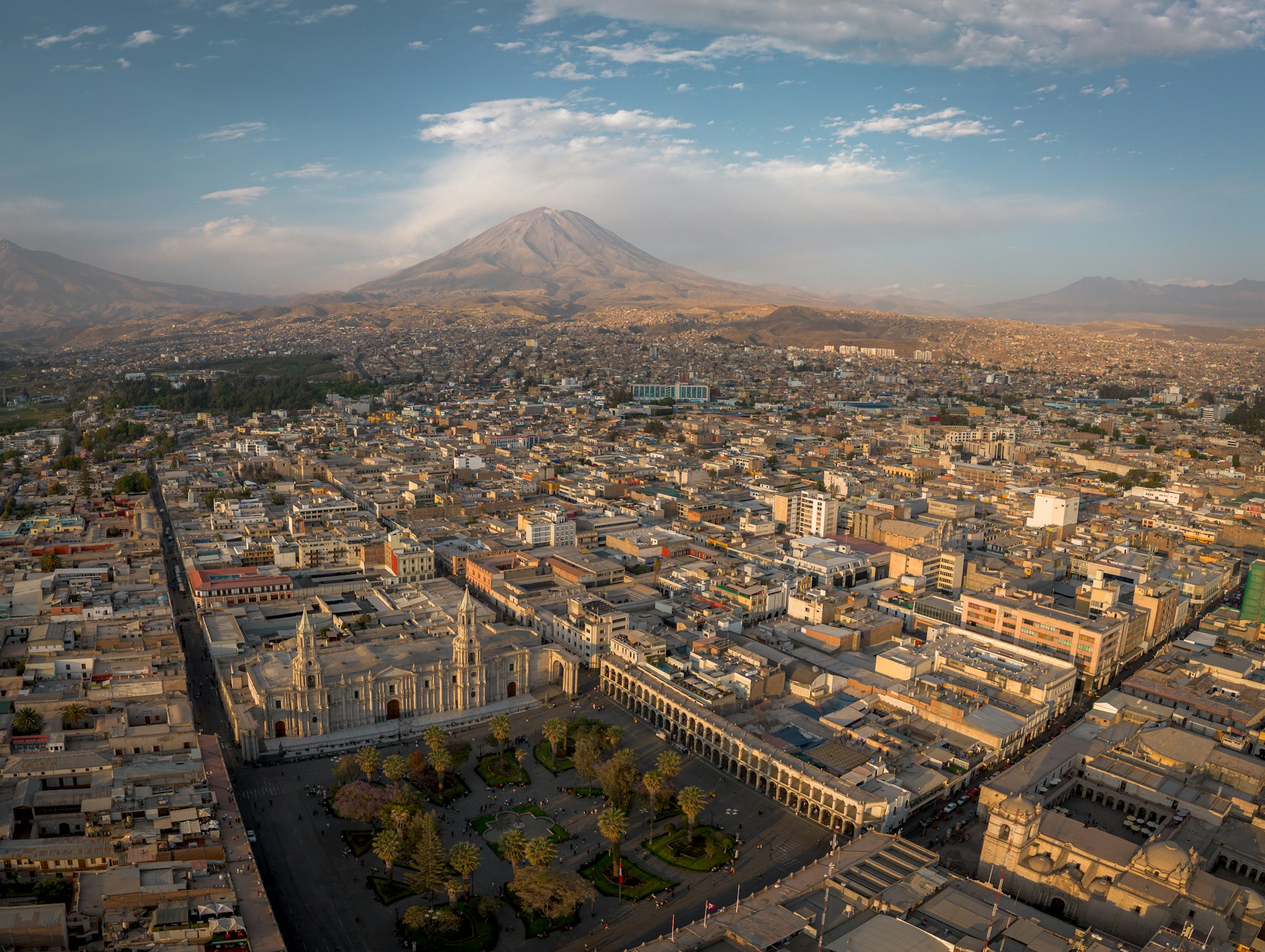A panoramic view of a city with a mountain in the background