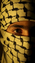 A man wearing a yellow and black patterned mask