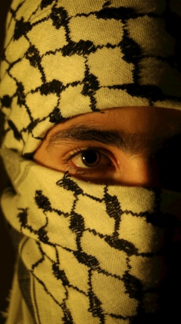 A man wearing a yellow and black patterned mask