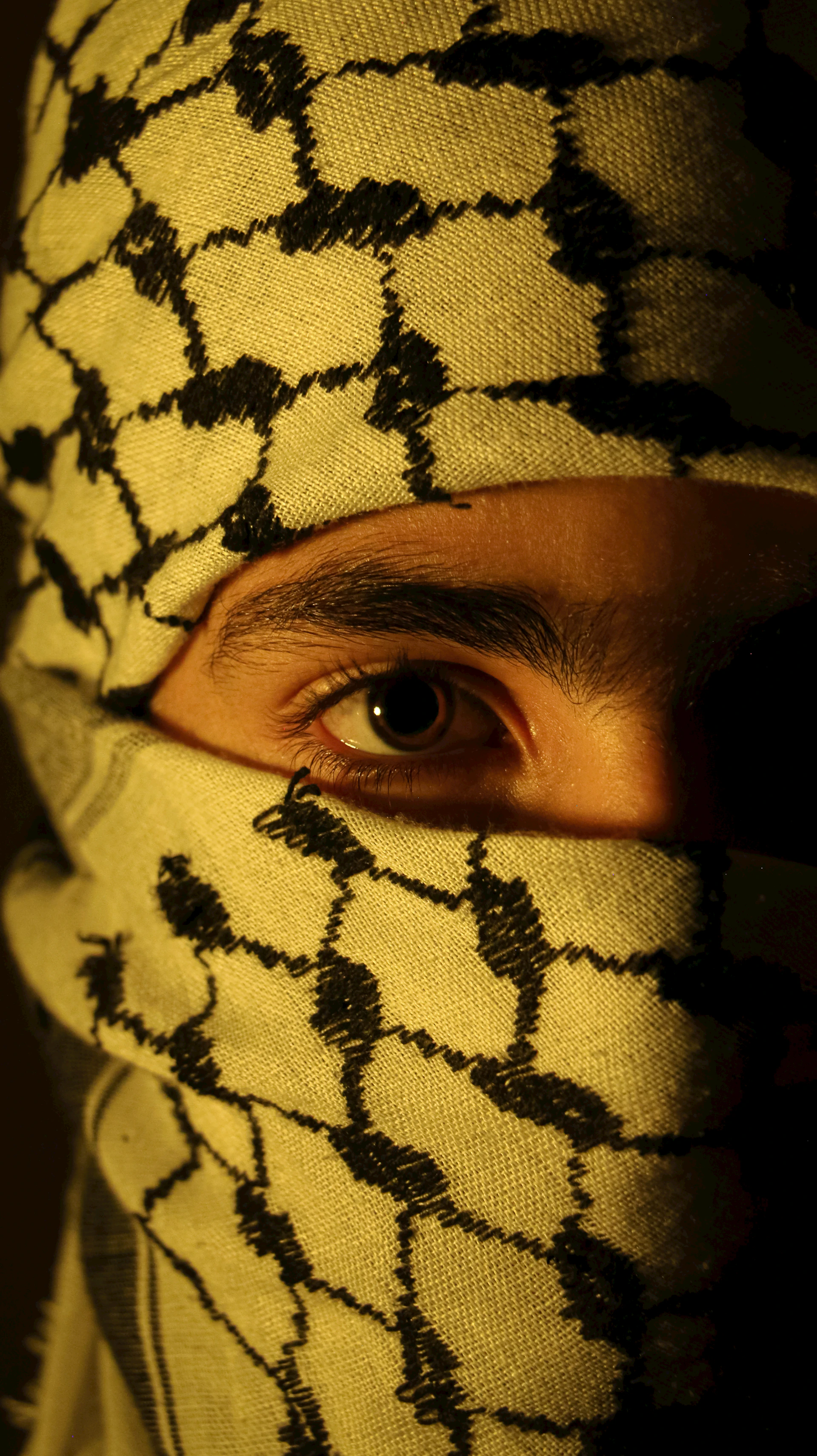 A man wearing a yellow and black patterned mask
