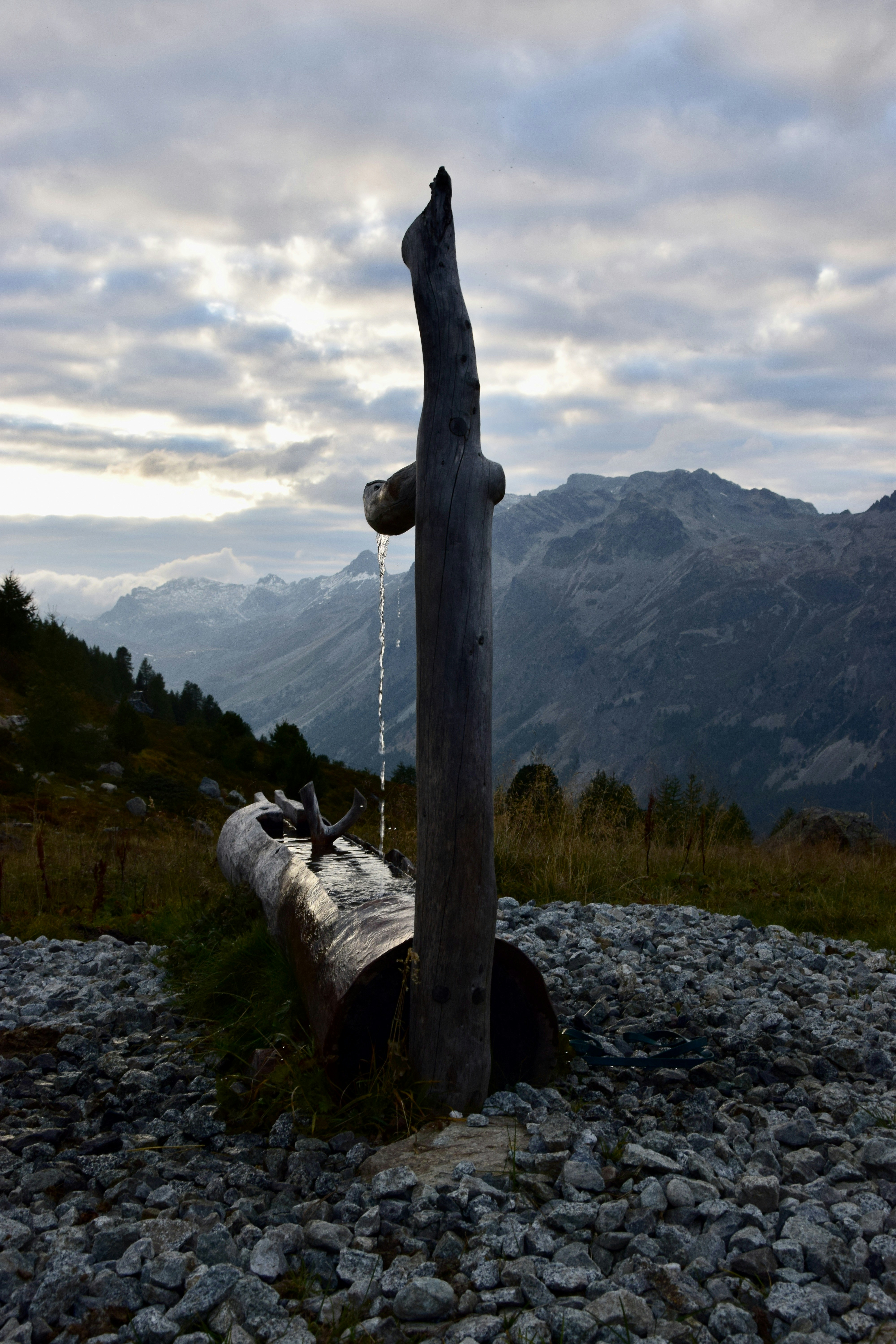 A wooden bench sitting on top of a rocky hillside