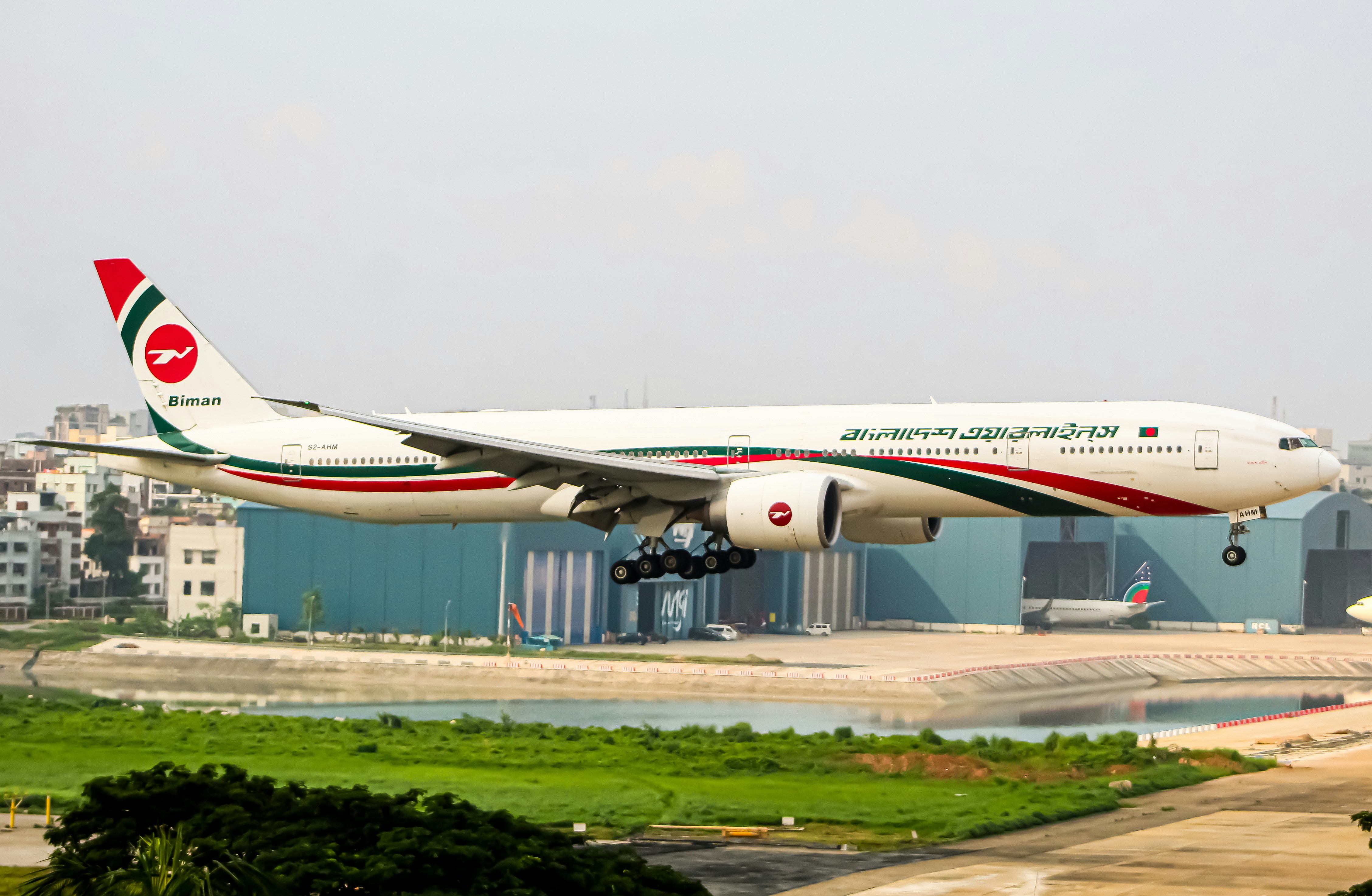 A large jetliner taking off from an airport runway, Biman Bangladesh Airlines Boeing 777-300ER