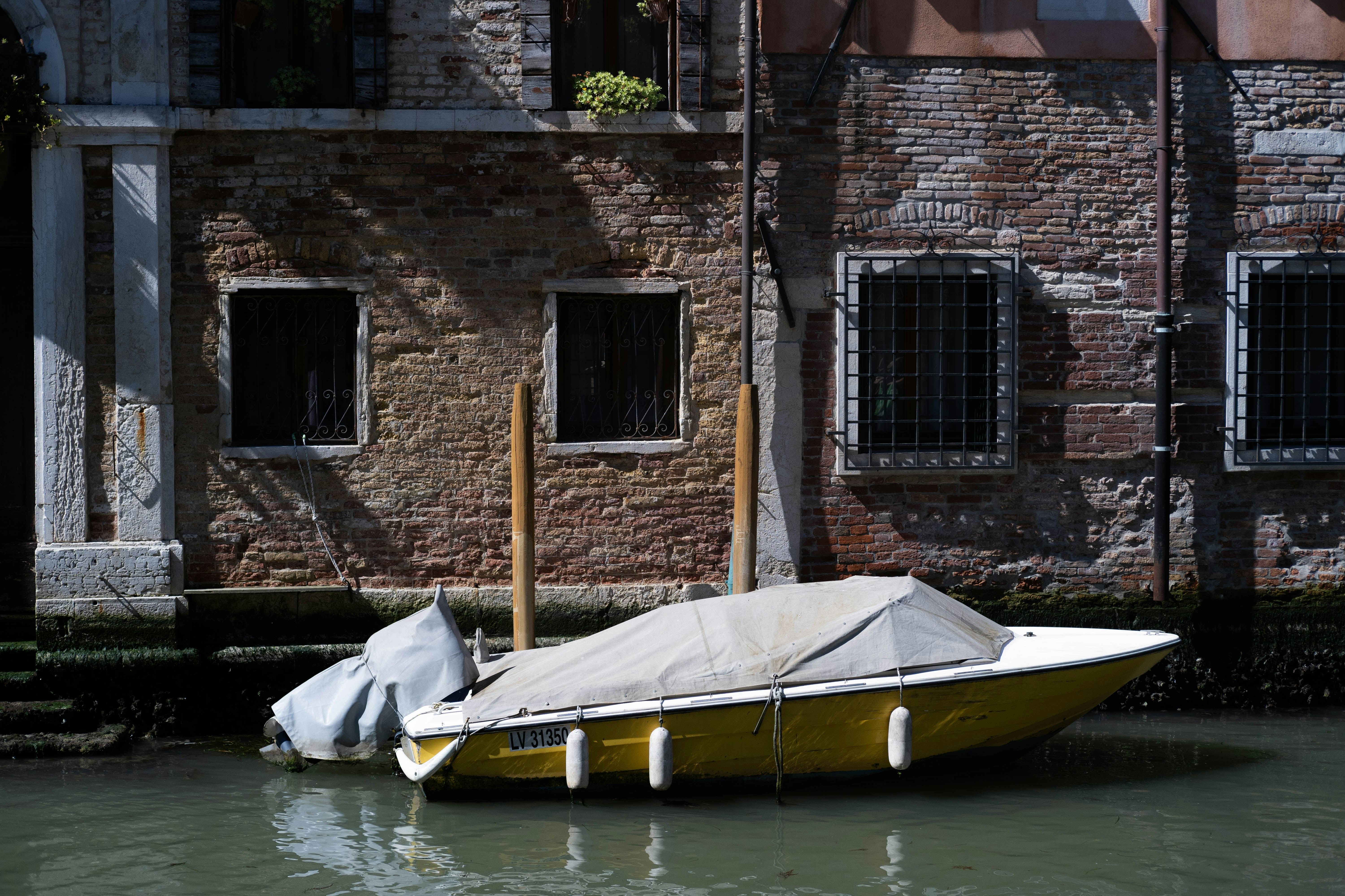 A yellow boat sitting in the middle of a body of water