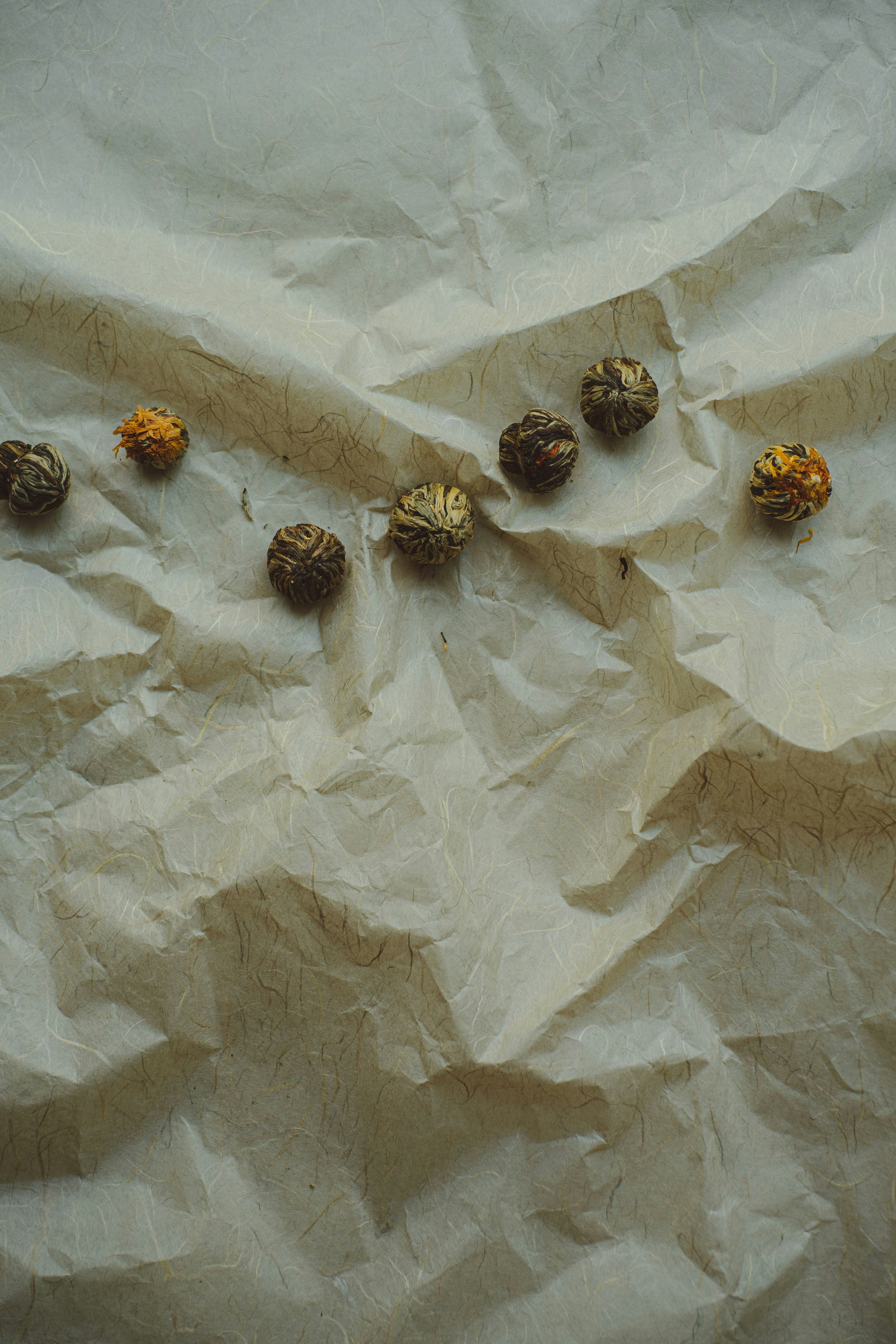 A bunch of nuts sitting on top of a piece of paper