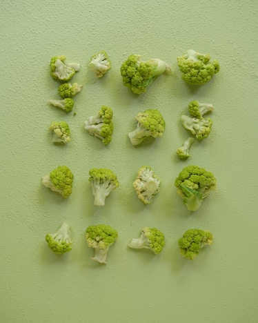 A bunch of broccoli on a green surface