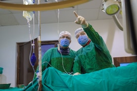 A couple of doctors in scrubs in a room