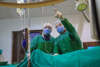 A couple of doctors in scrubs in a room
