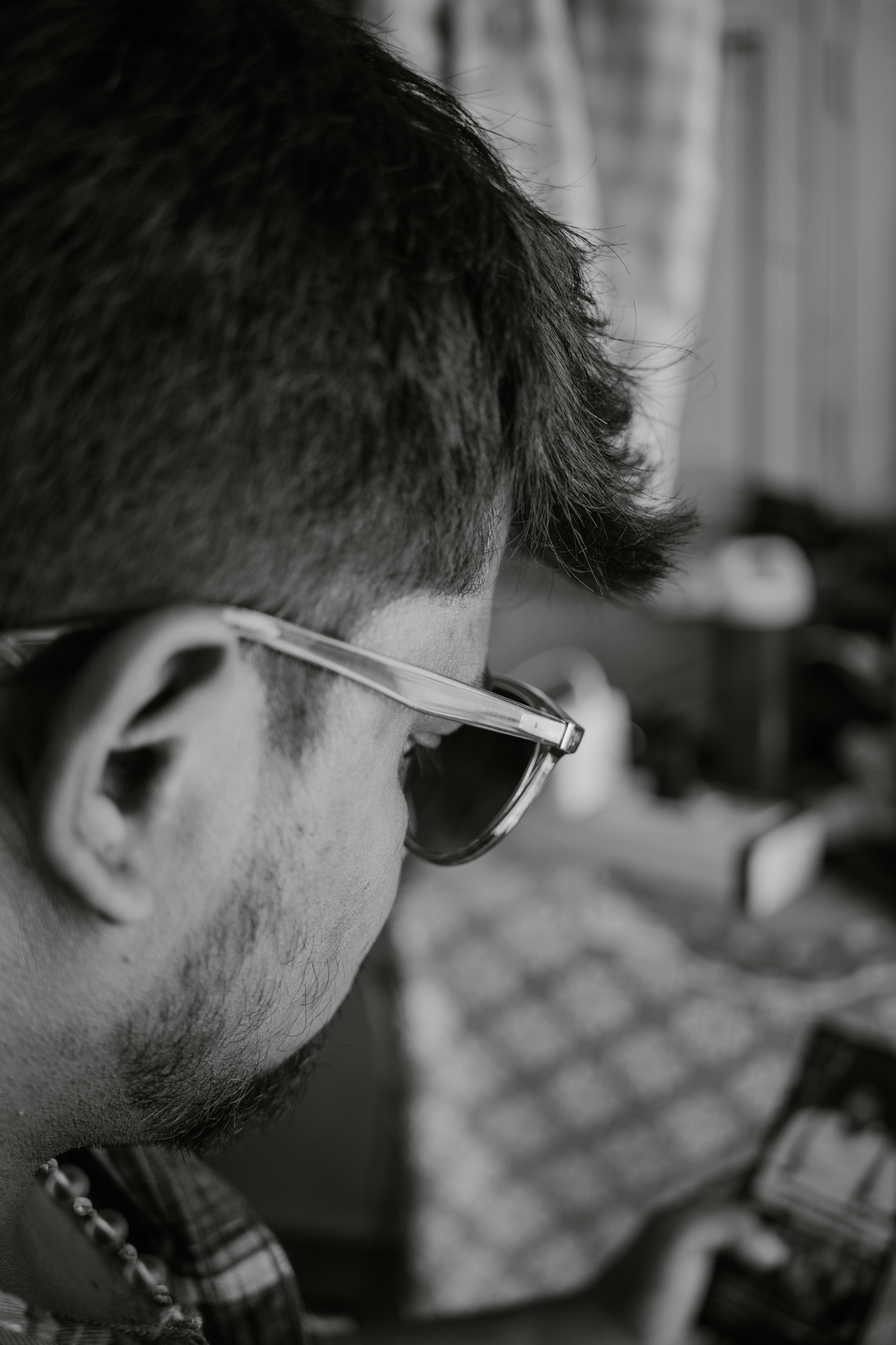 A man wearing glasses looking at a cell phone