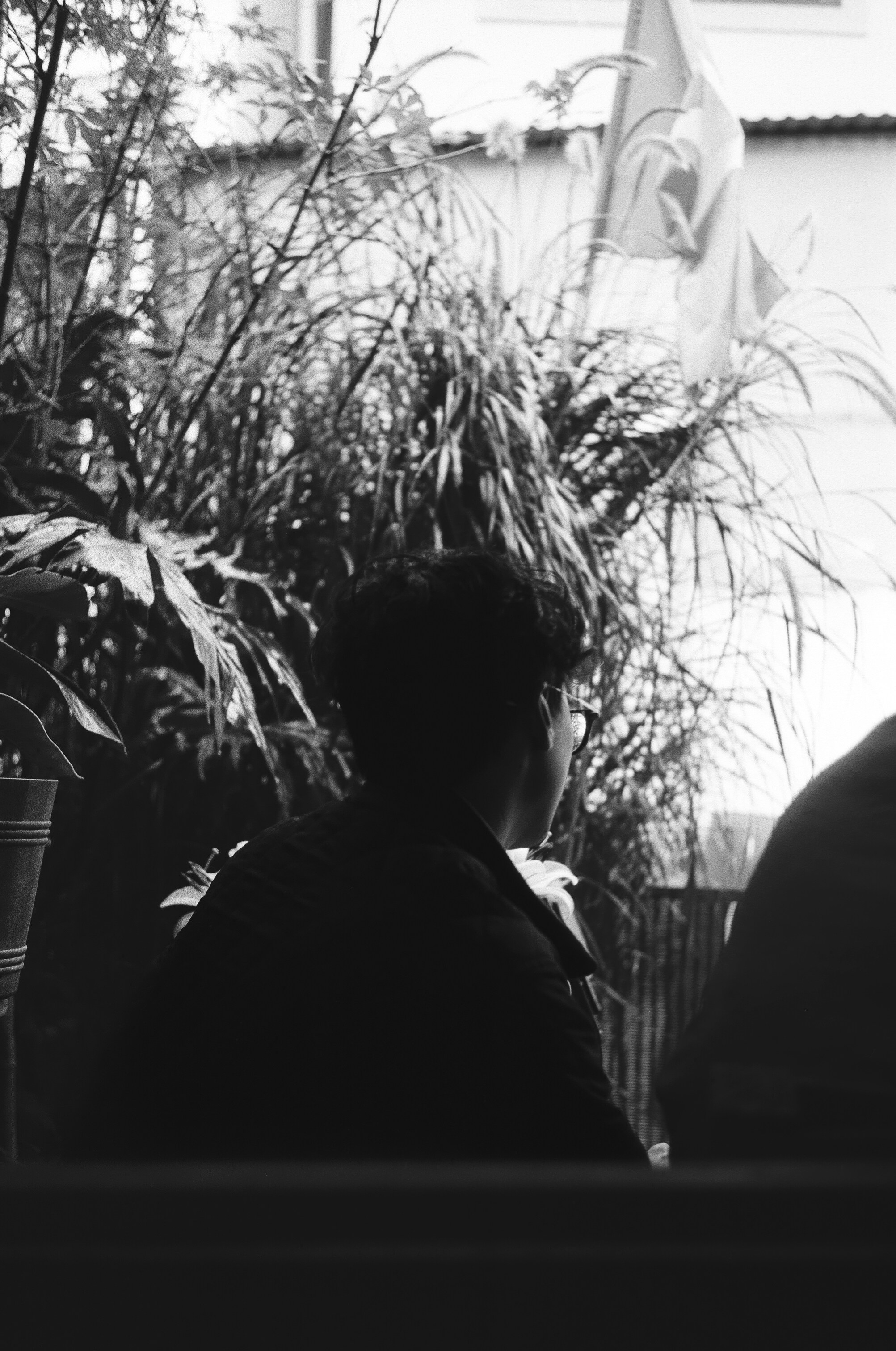 Una foto en blanco y negro de una persona sentada en una mesa