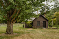 A small cabin in the middle of a field