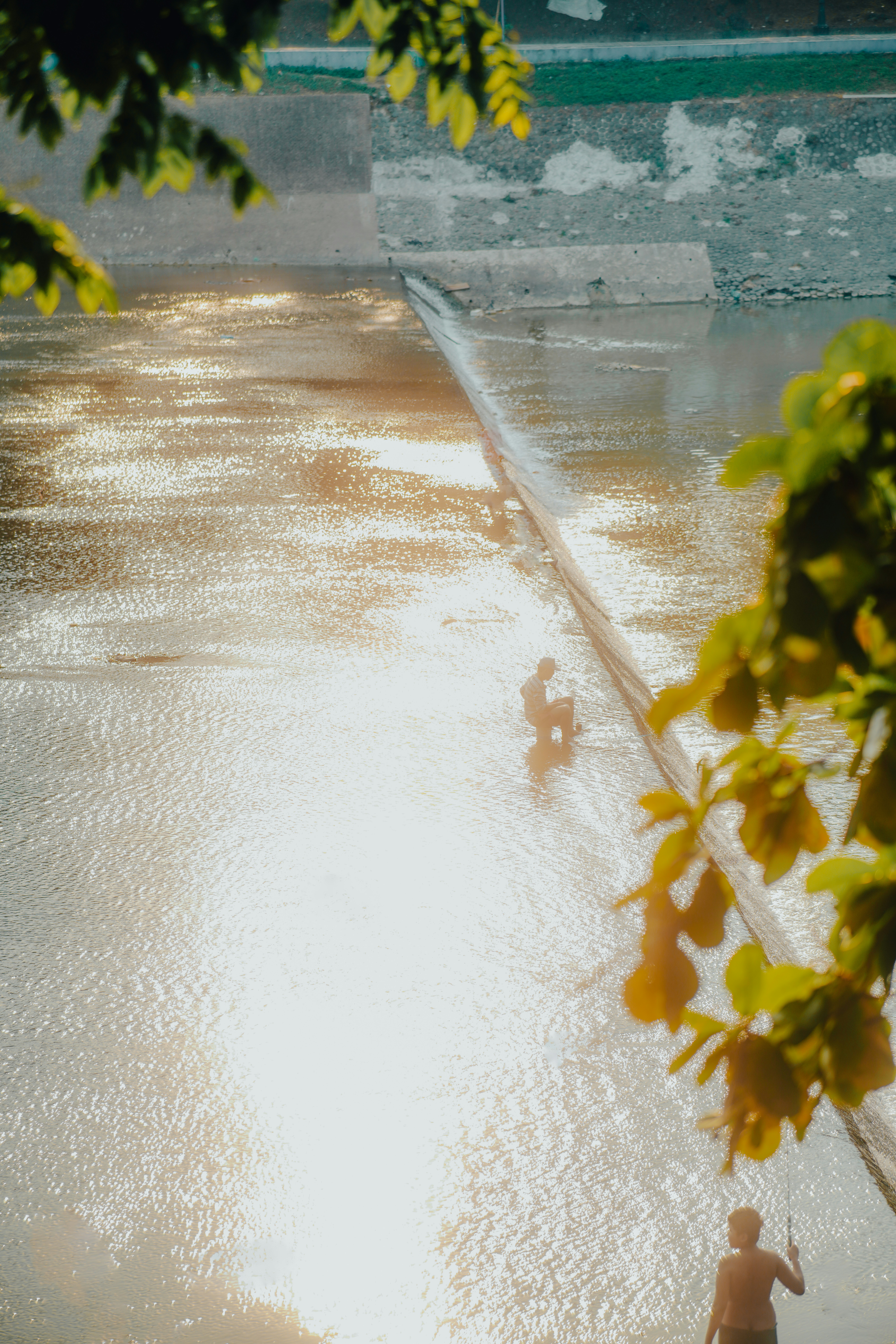 A couple of people riding water skis on a body of water