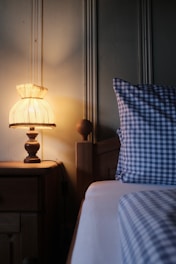 A bedroom with a bed and a night stand