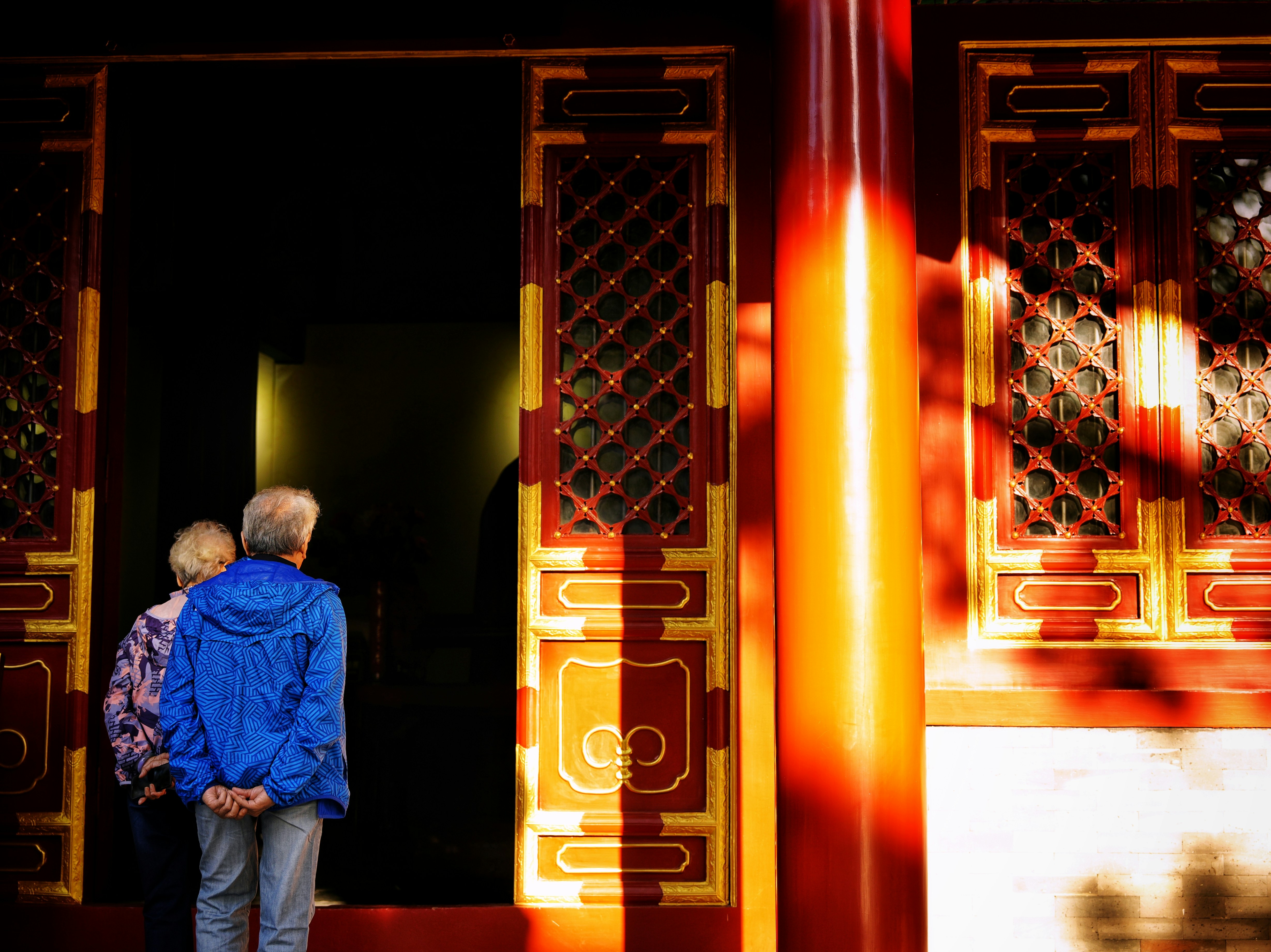 A man and a woman standing in front of a doorway