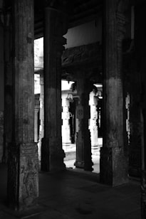 A black and white photo of pillars in a building