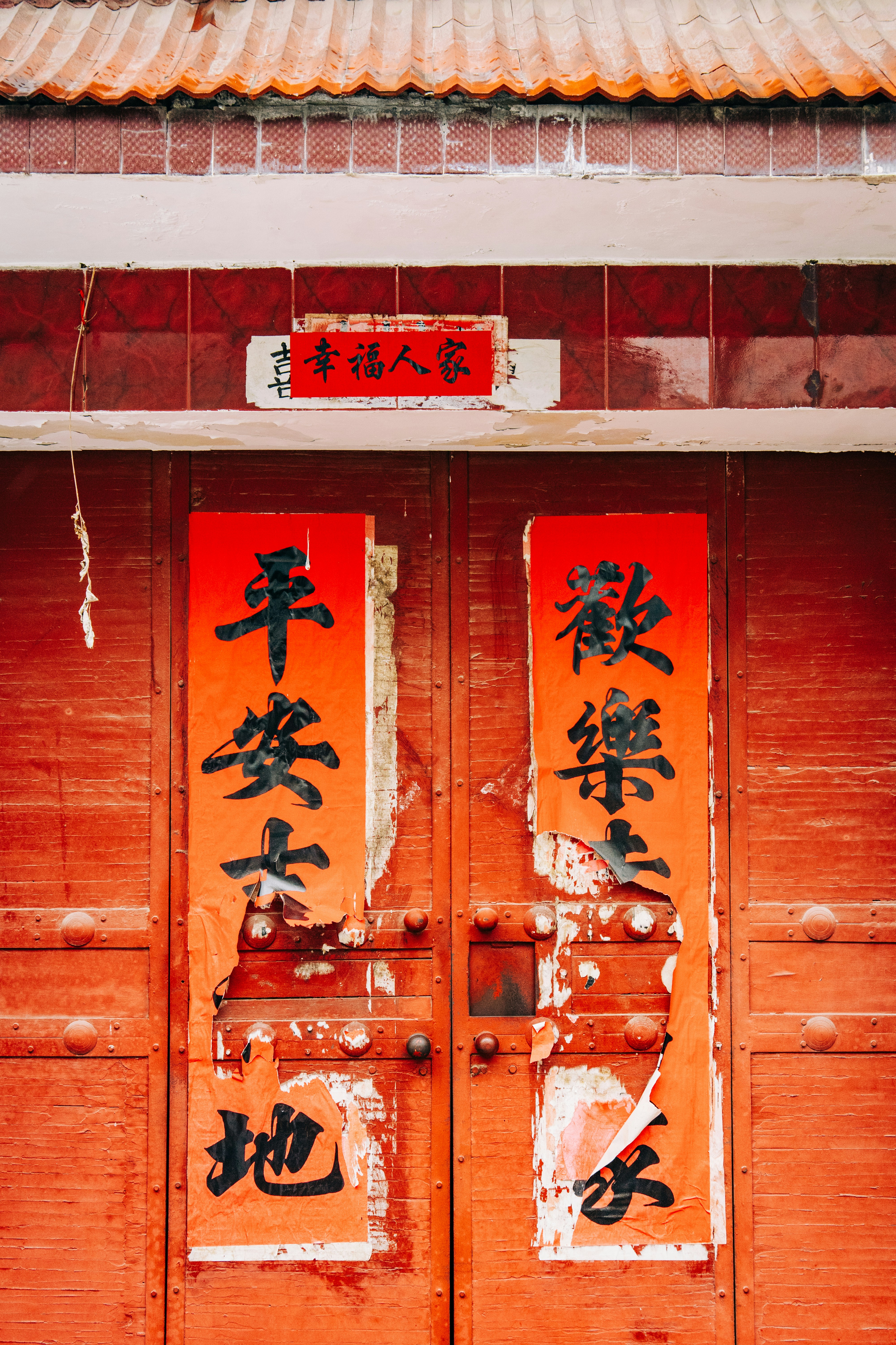 Two red doors with asian writing on them