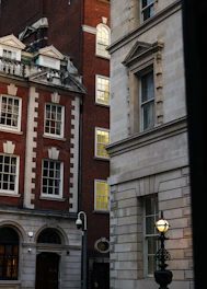 A tall brick building with a clock on it's side
