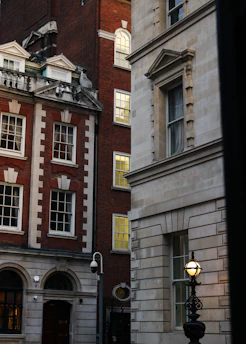 A tall brick building with a clock on it's side