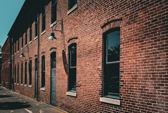 A red brick building with a black door and windows