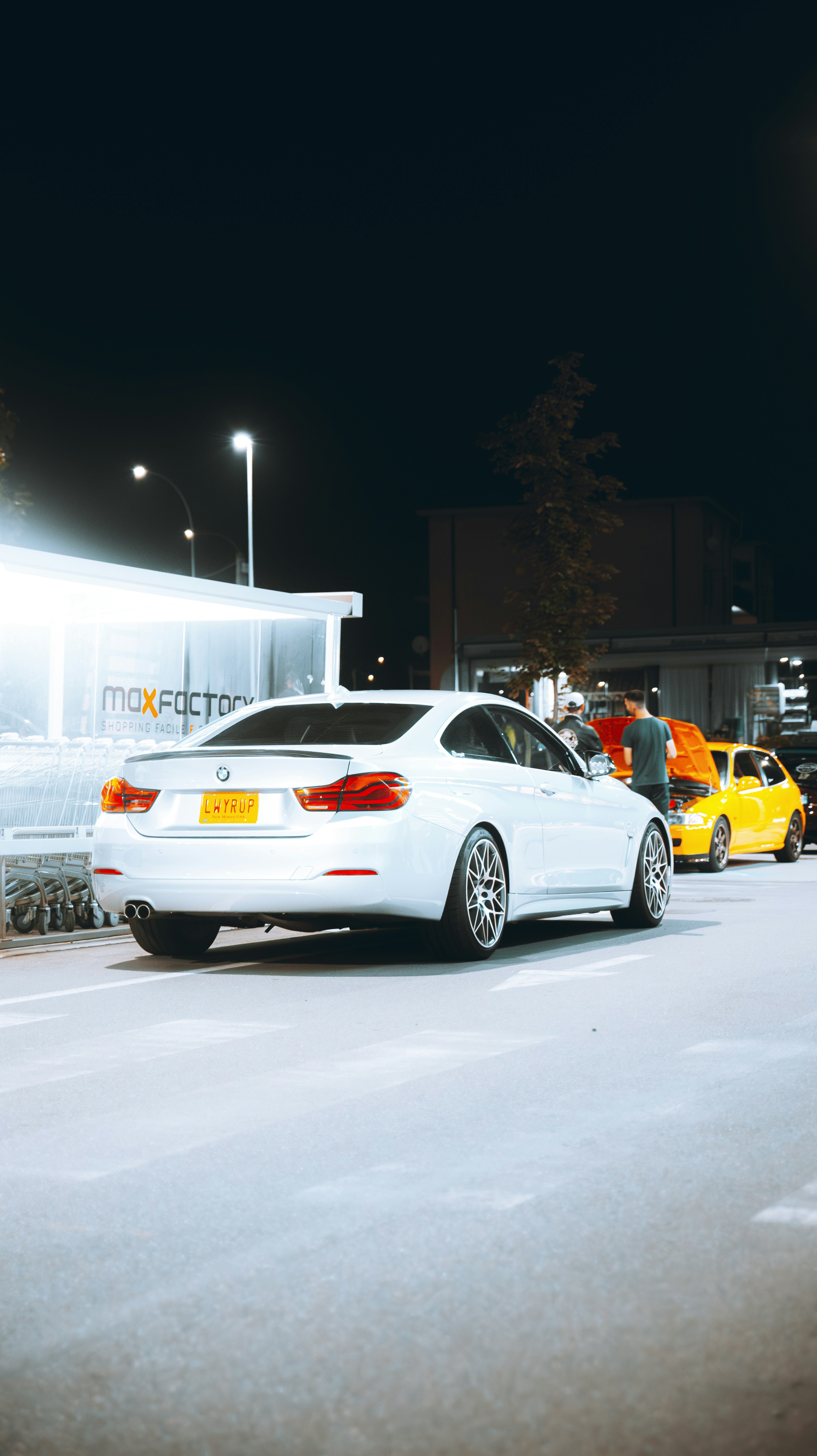 A white car parked on the side of a road