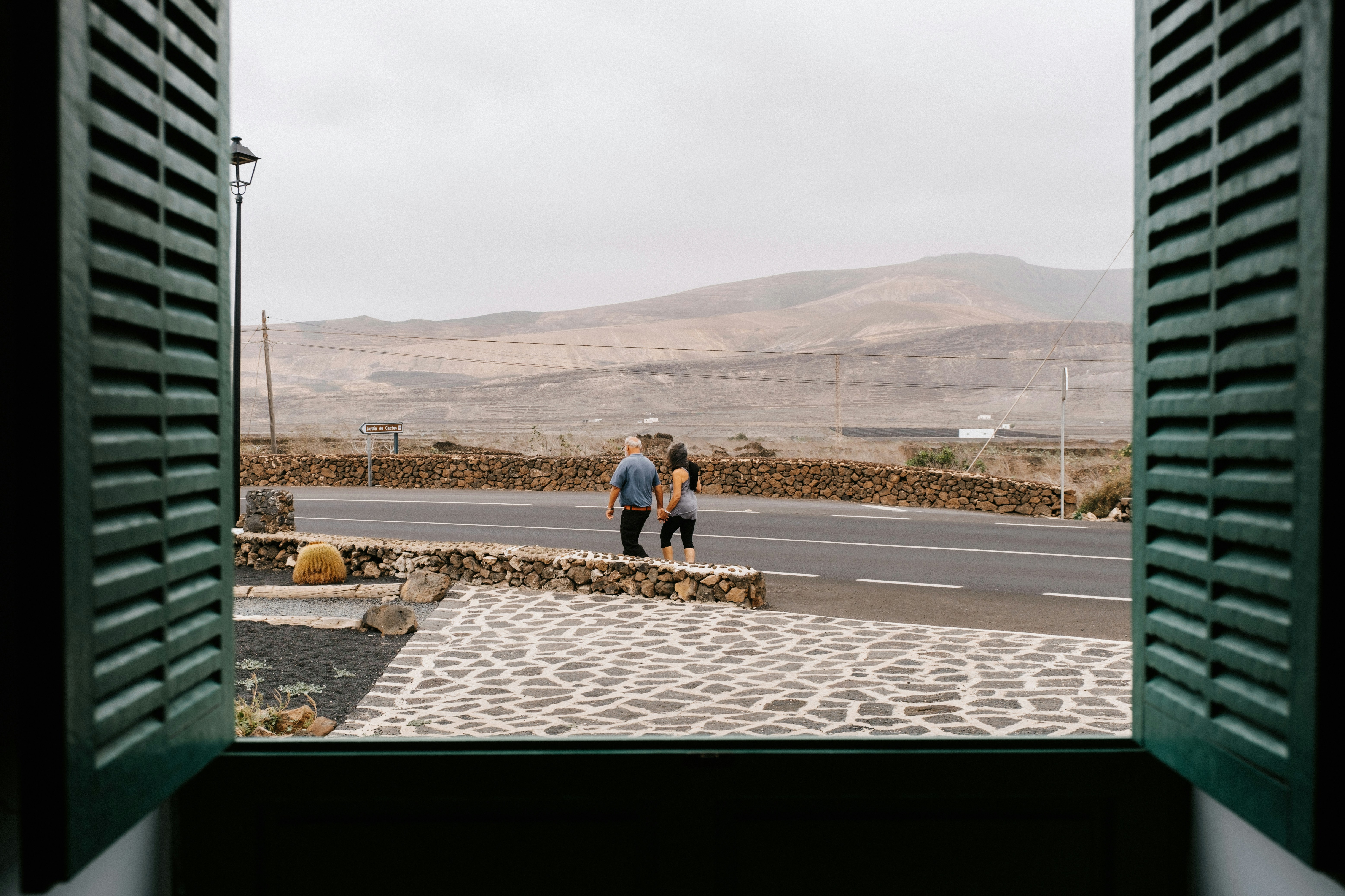 A couple of people standing outside of a window