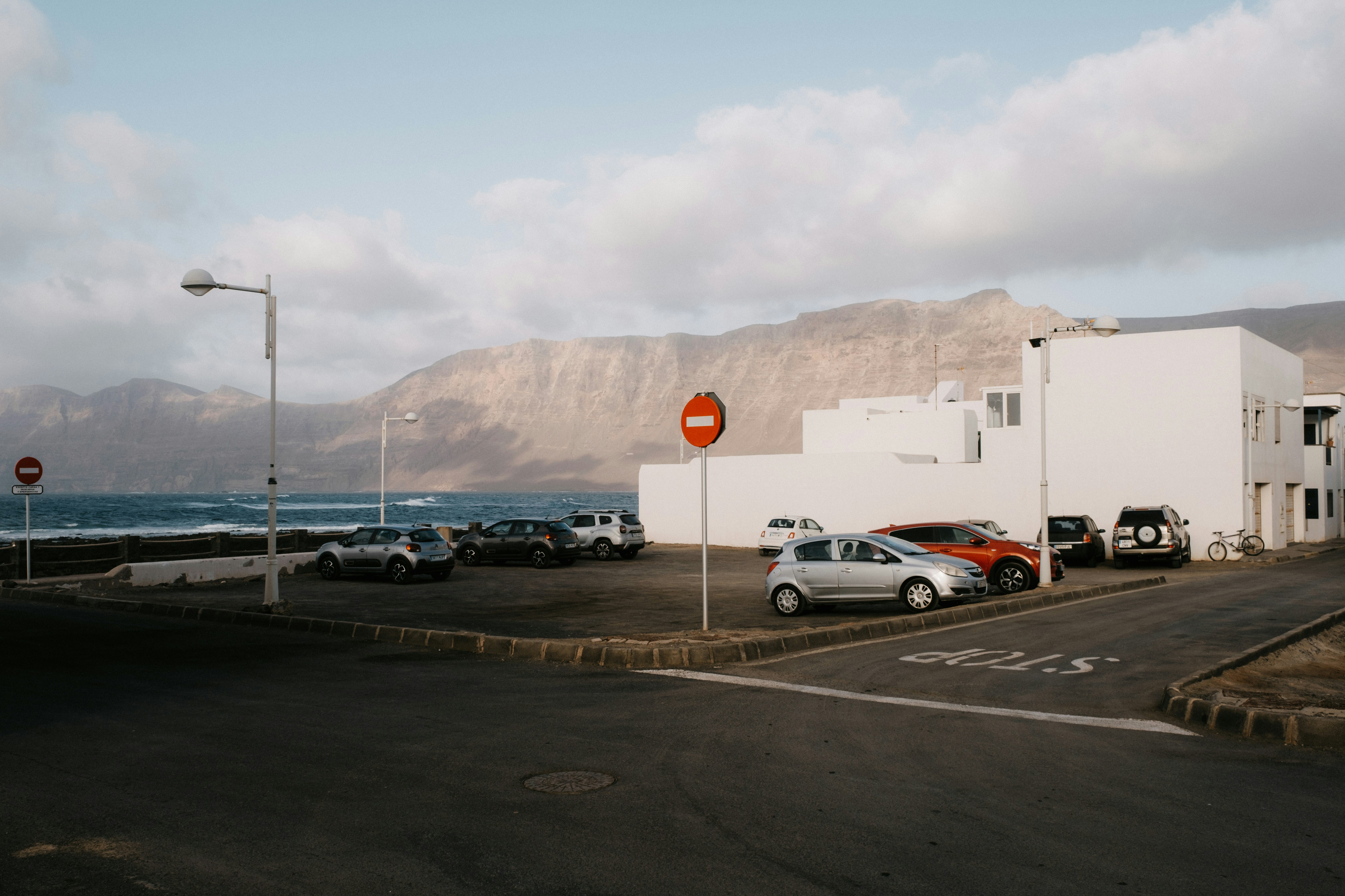A parking lot with cars parked on the side of the road photo Free