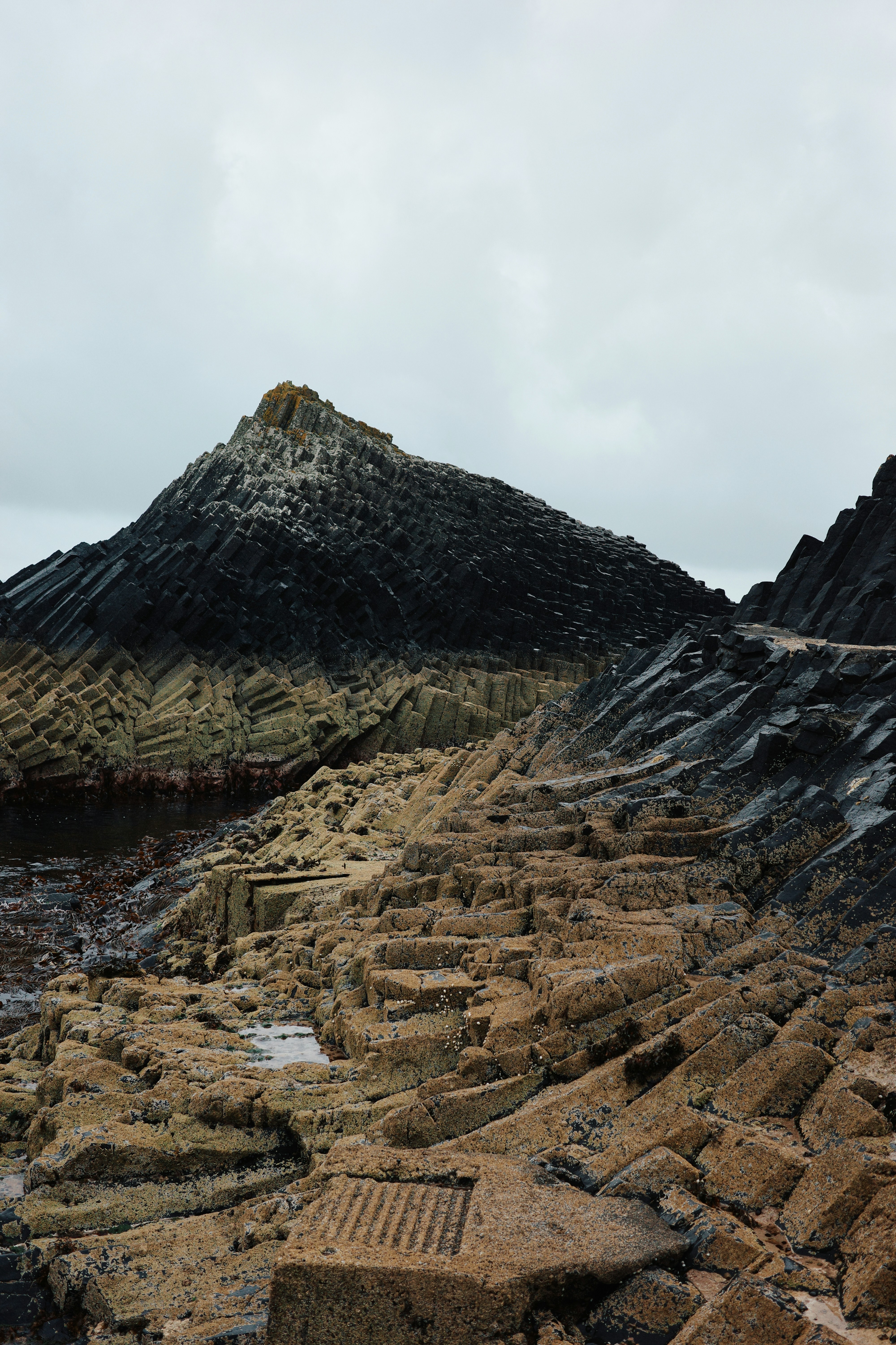 A large pile of rocks sitting on top of a beach