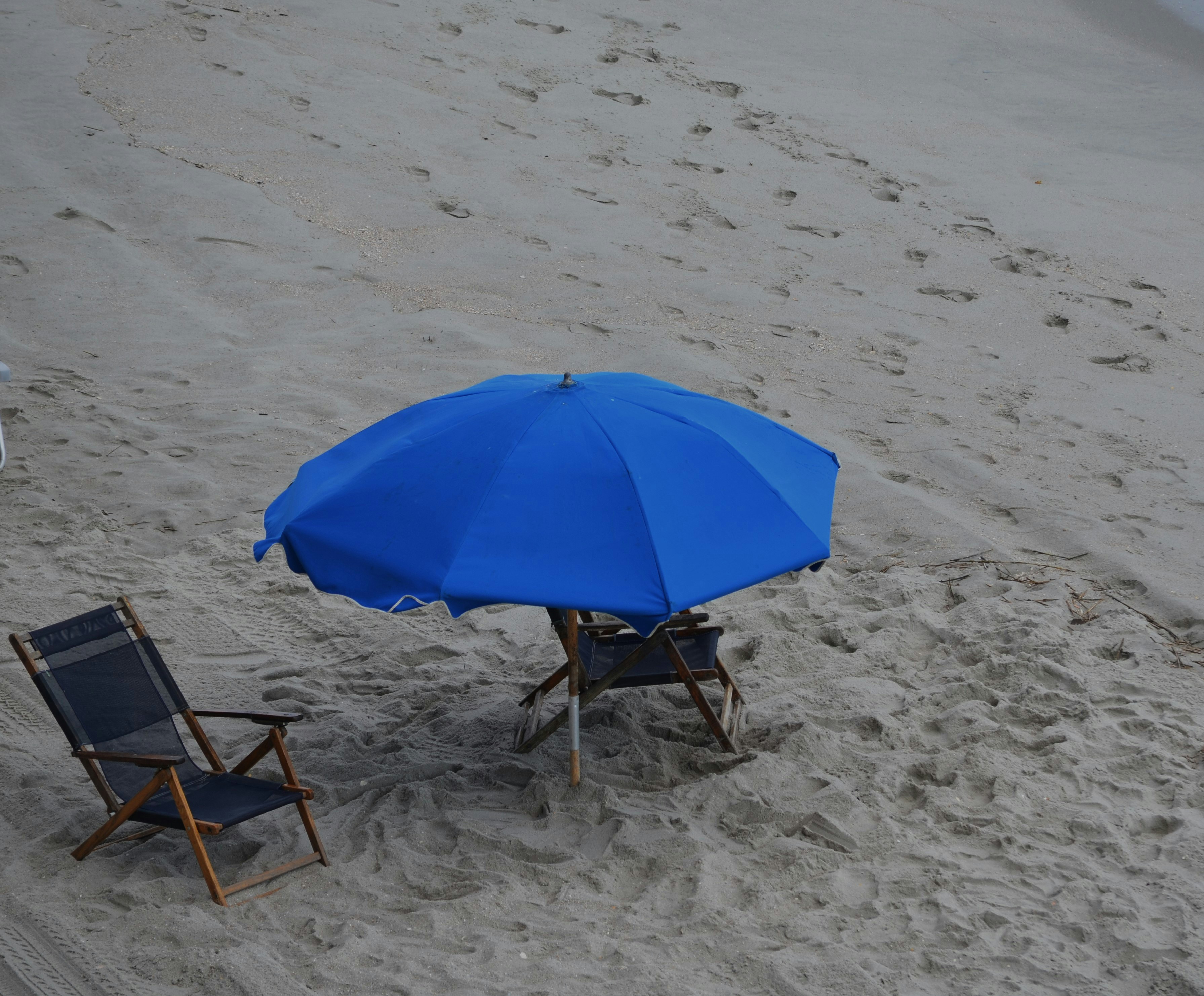 Vacant Beach chairs and Blue Beach Umbrella