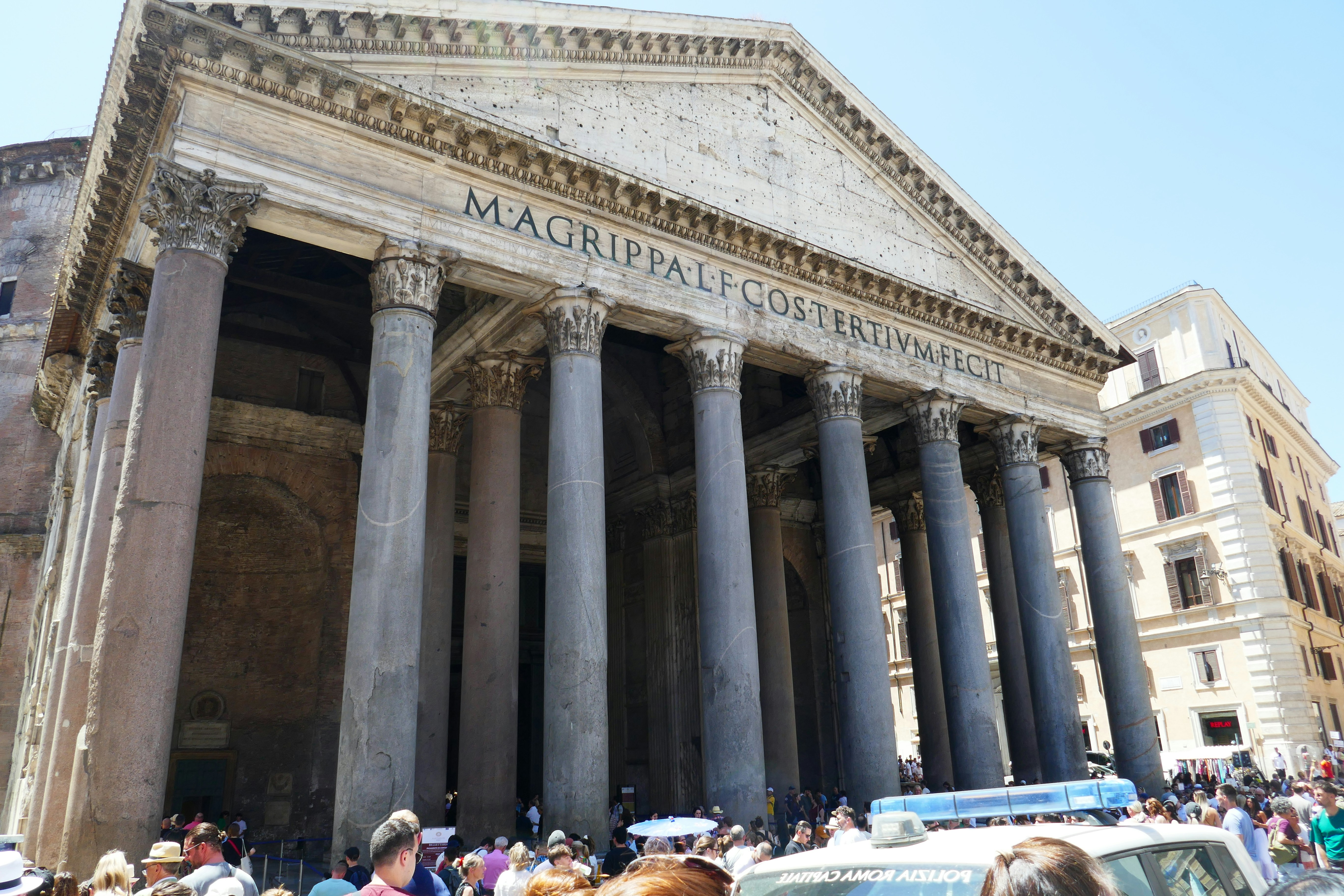 A group of people standing in front of a building, Pantheon in the heart of Rome