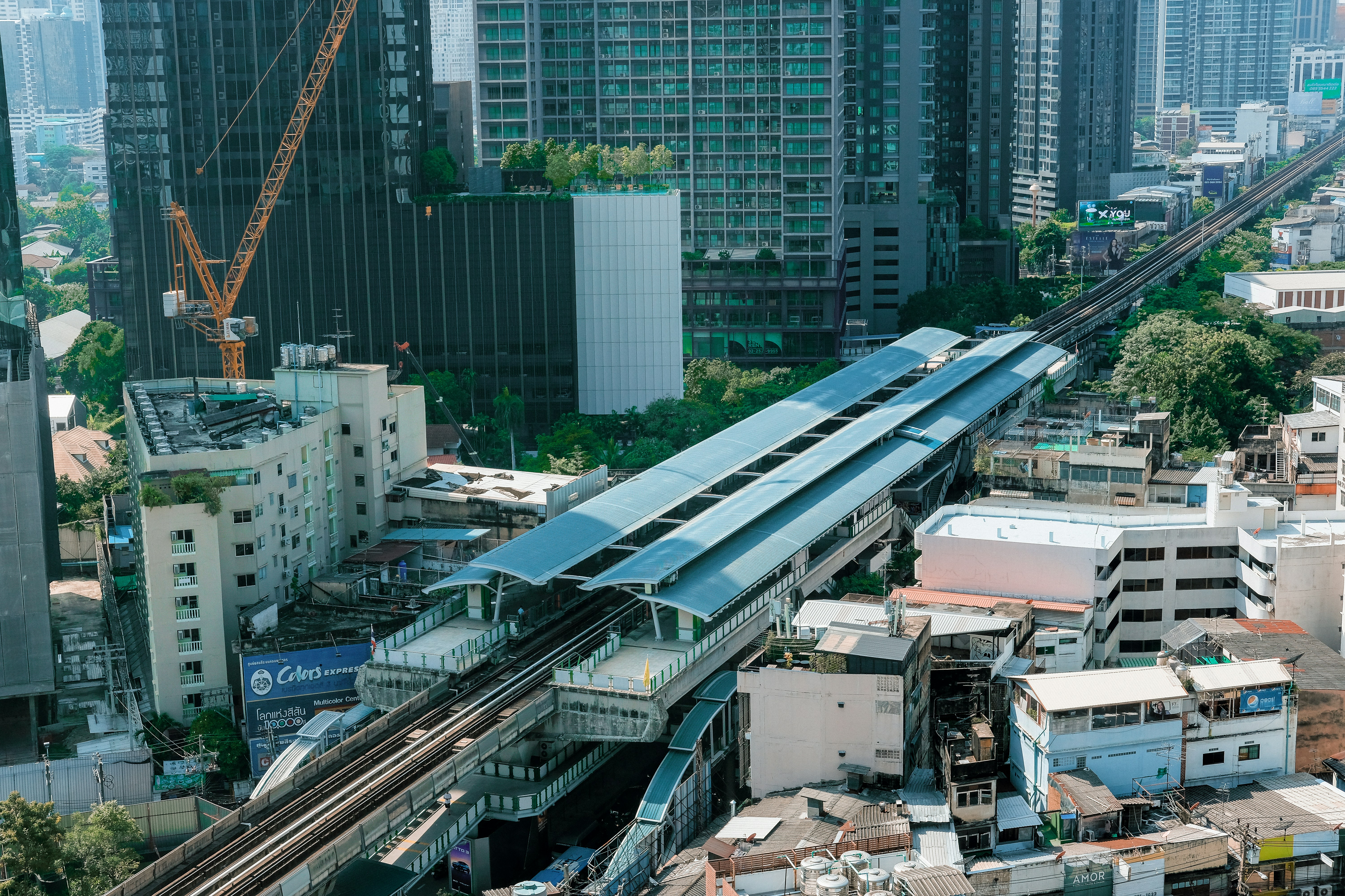 A train traveling through a city next to tall buildings