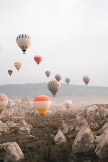 A bunch of hot air balloons flying in the sky