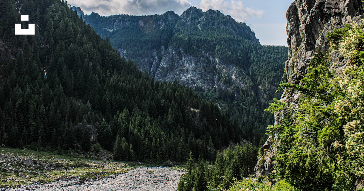 A view of a mountain with a river running through it photo β Free Mount ...