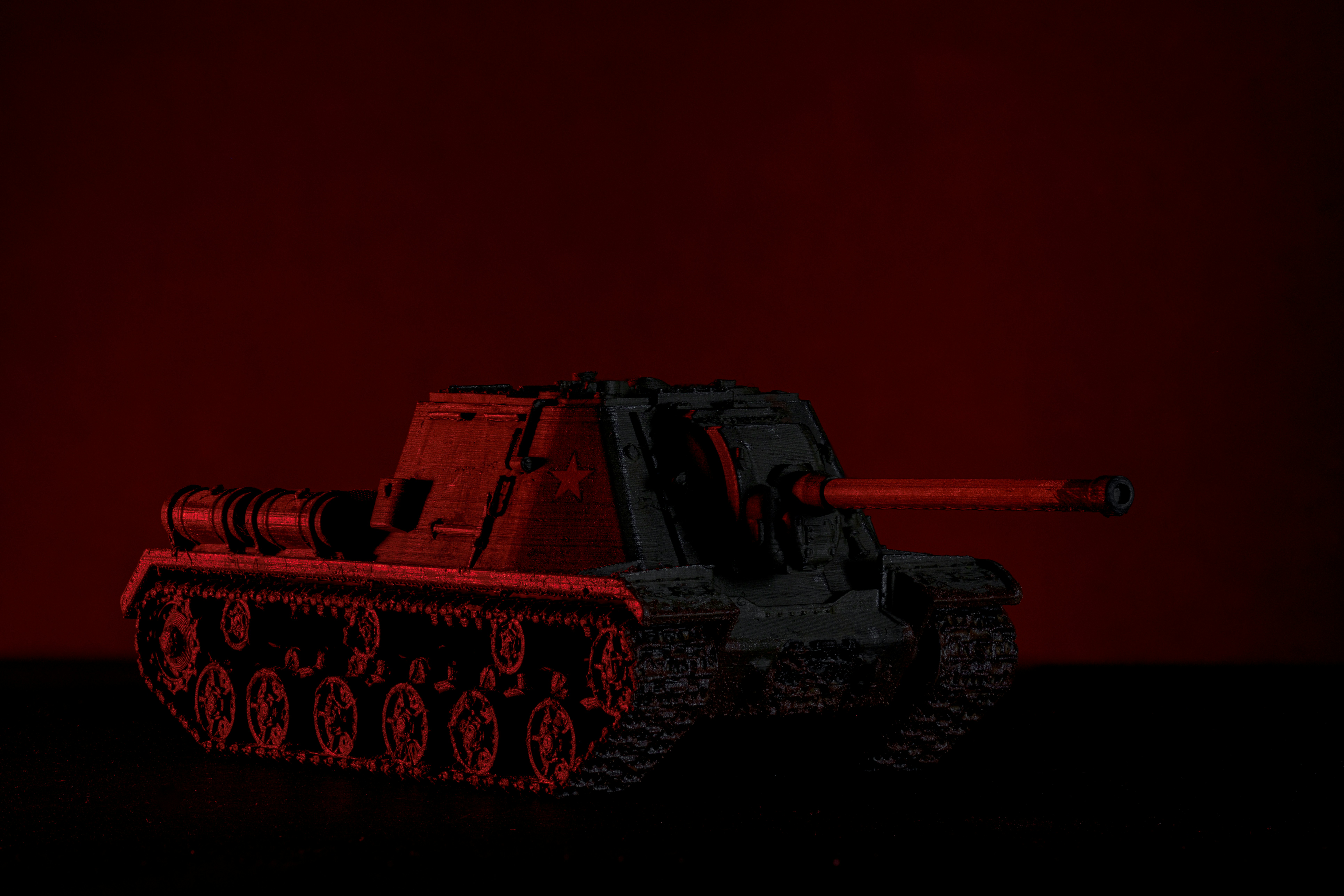 A red and black photo of a tank