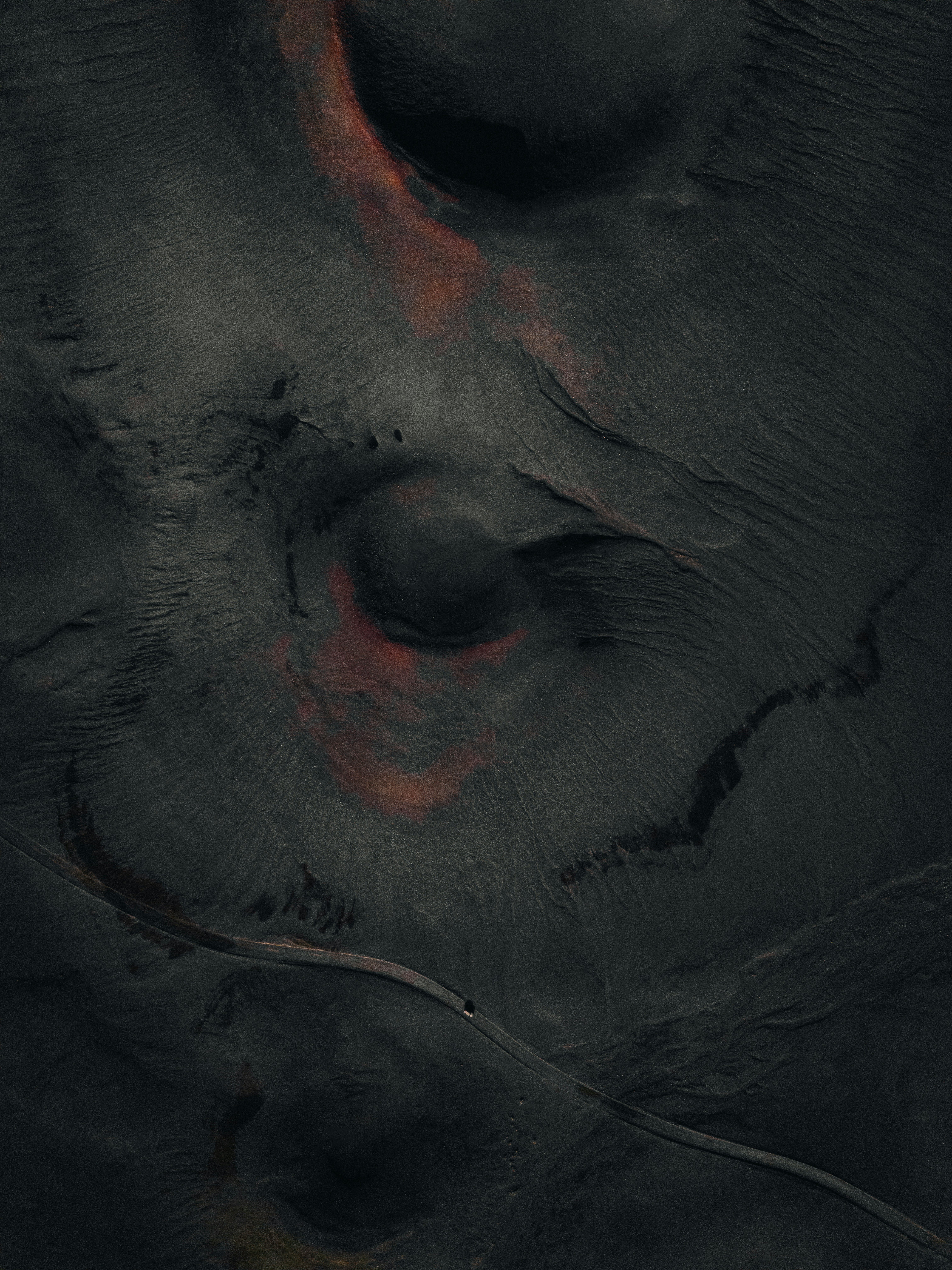 A close up of an elephant's skin with a red spot