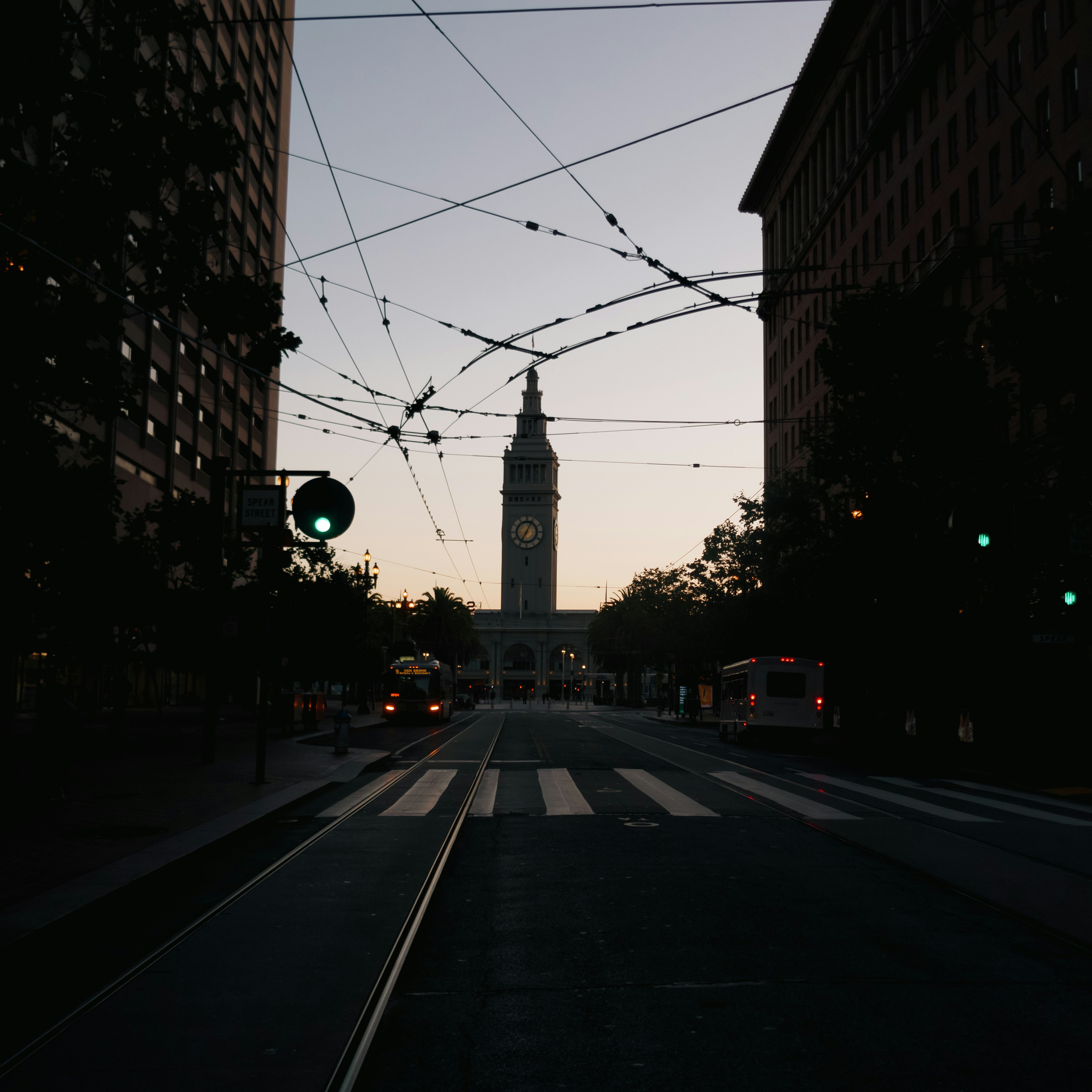 Blick auf eine Straße in der Stadt mit einem Uhrenturm im Hintergrund
