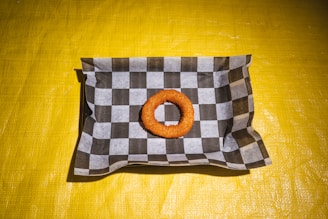 A bag with a donut on it sitting on a table