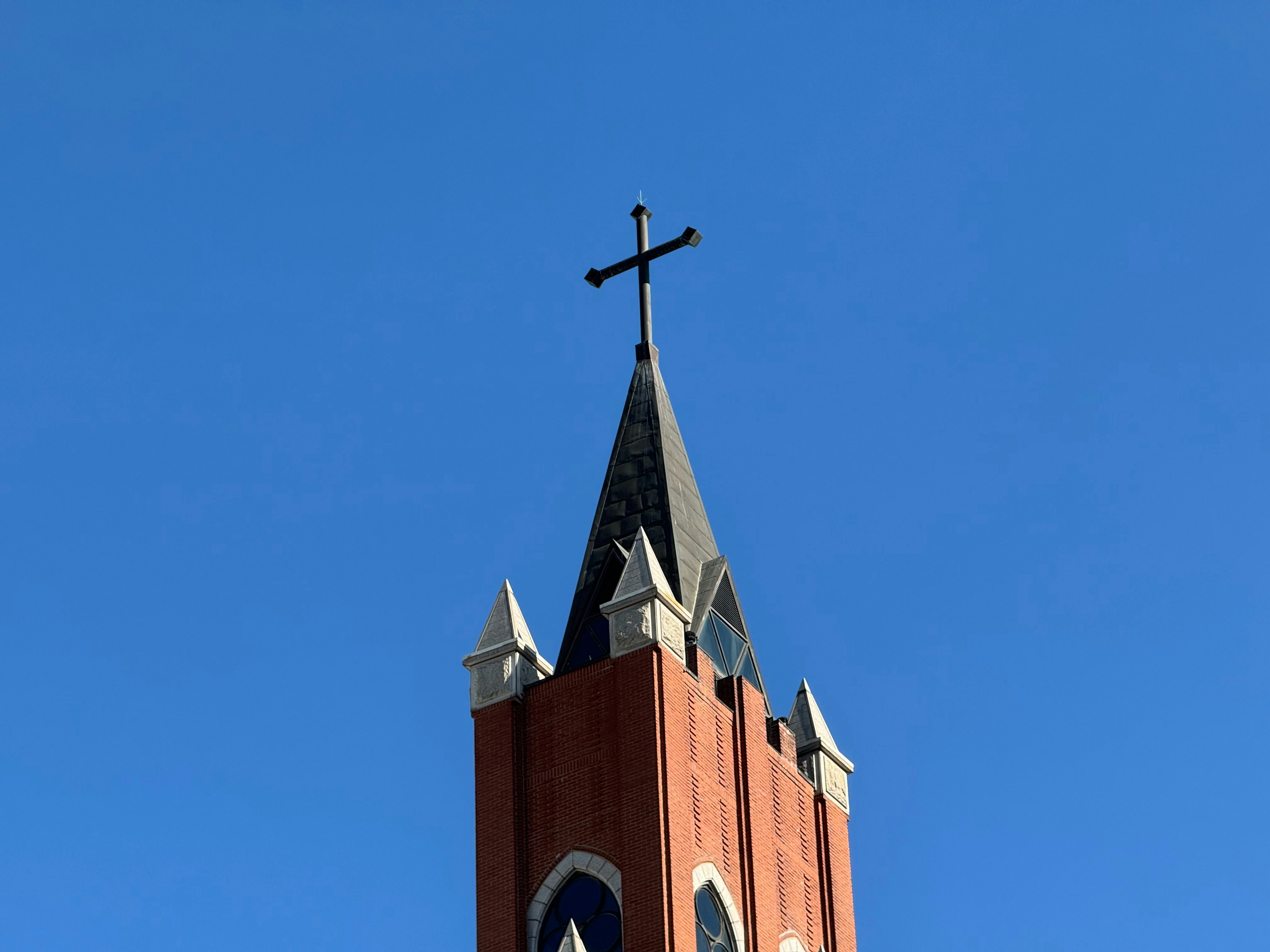 A church steeple with a cross on top