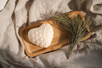 A heart shaped piece of bread on a cutting board