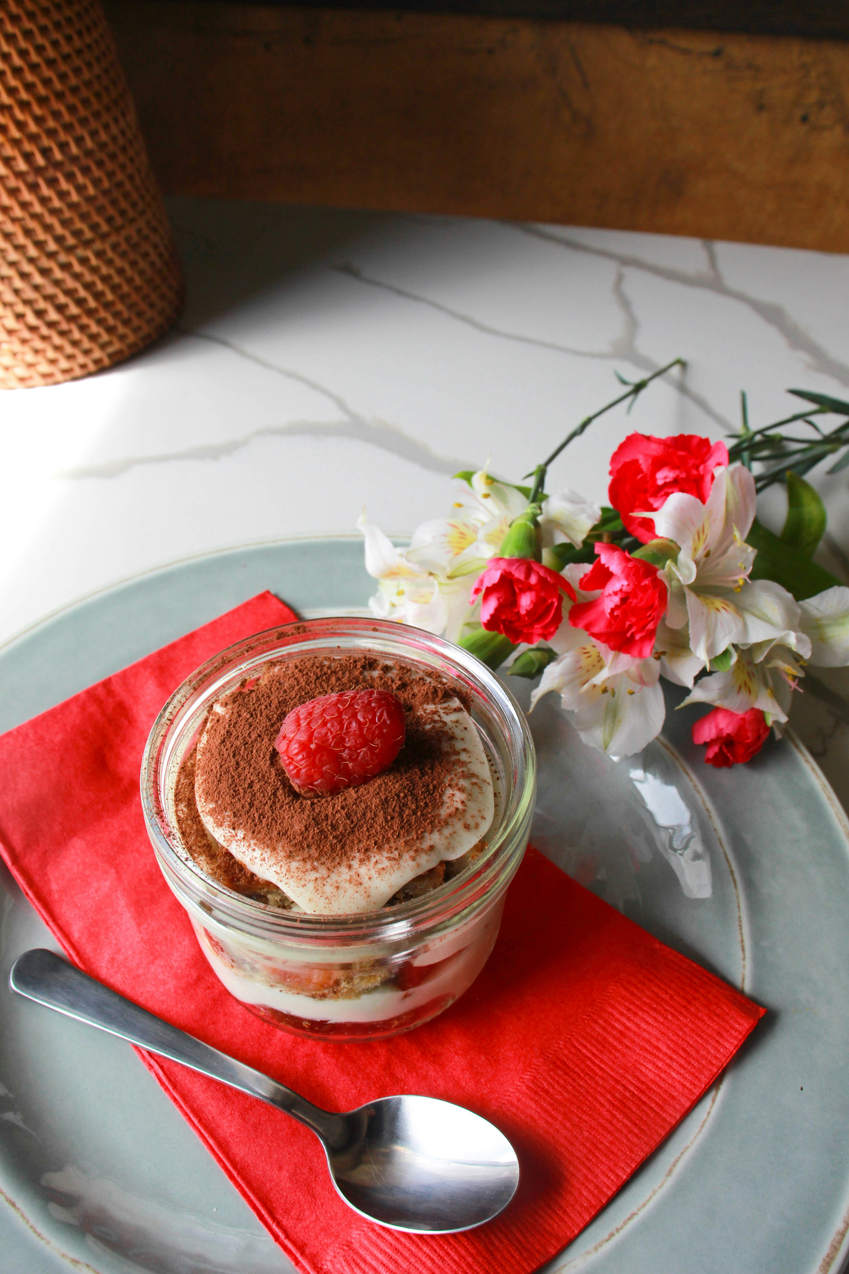 A dessert in a jar with a spoon on a plate