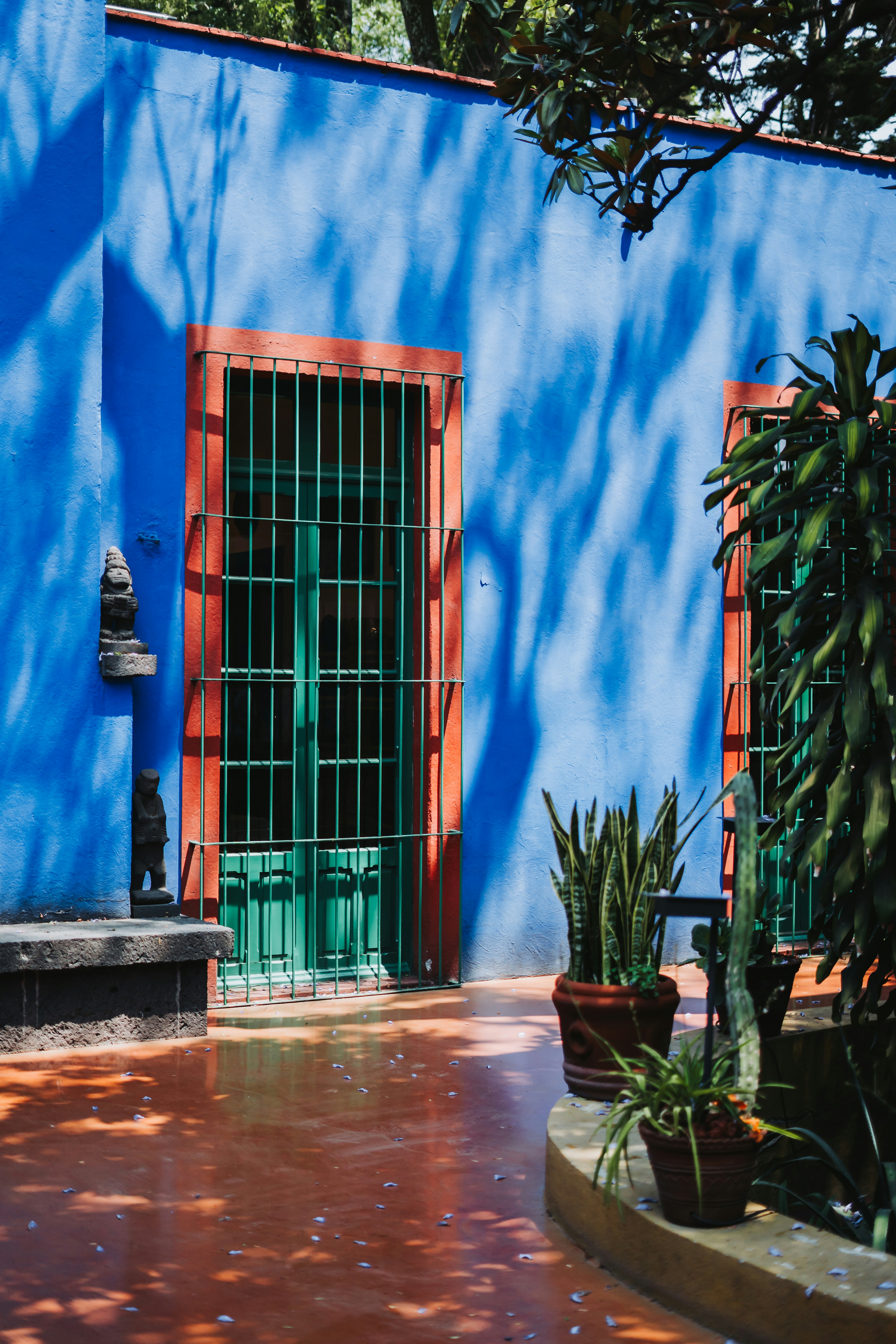 A blue building with a green door and window