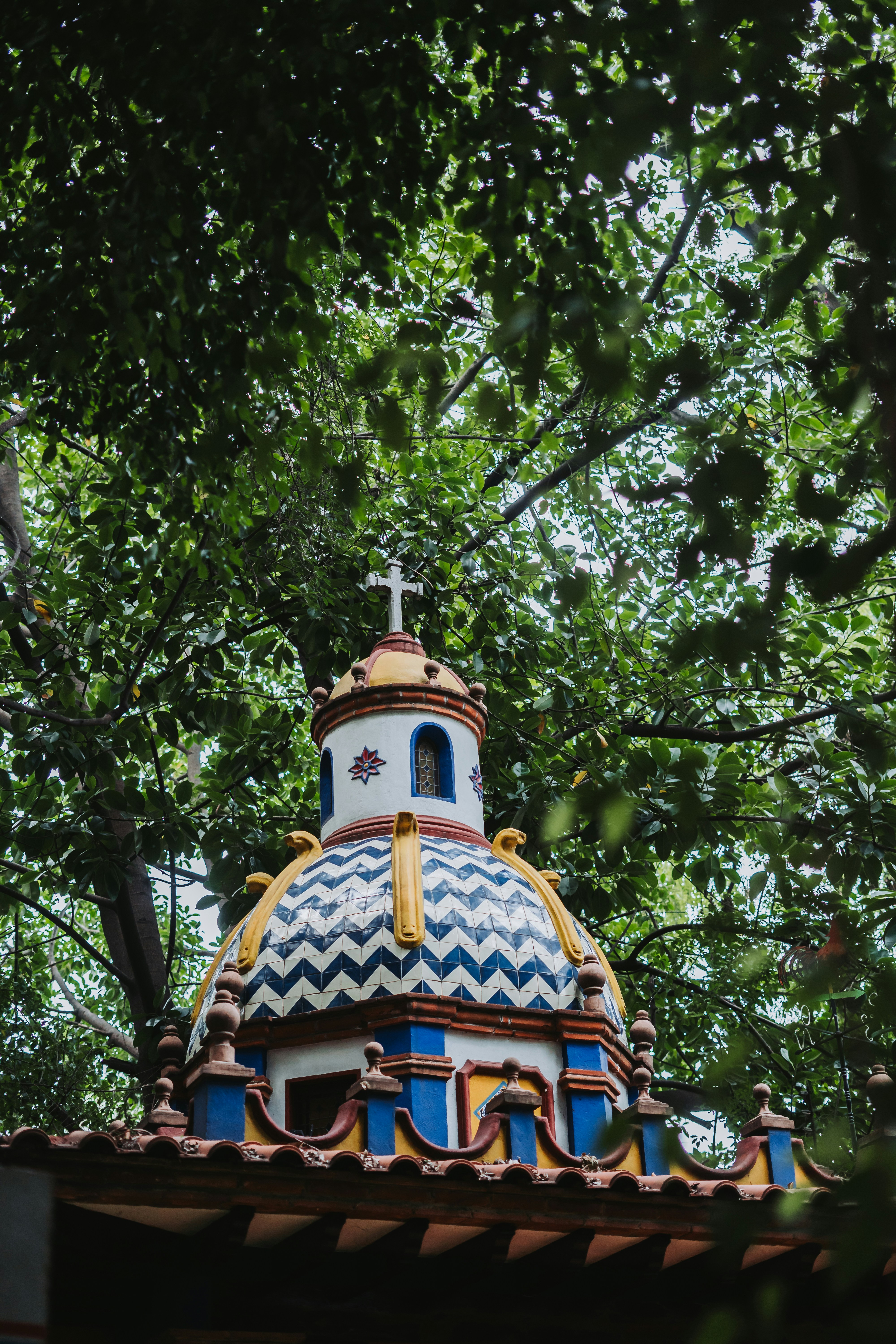 A building with a blue and yellow dome on top of it