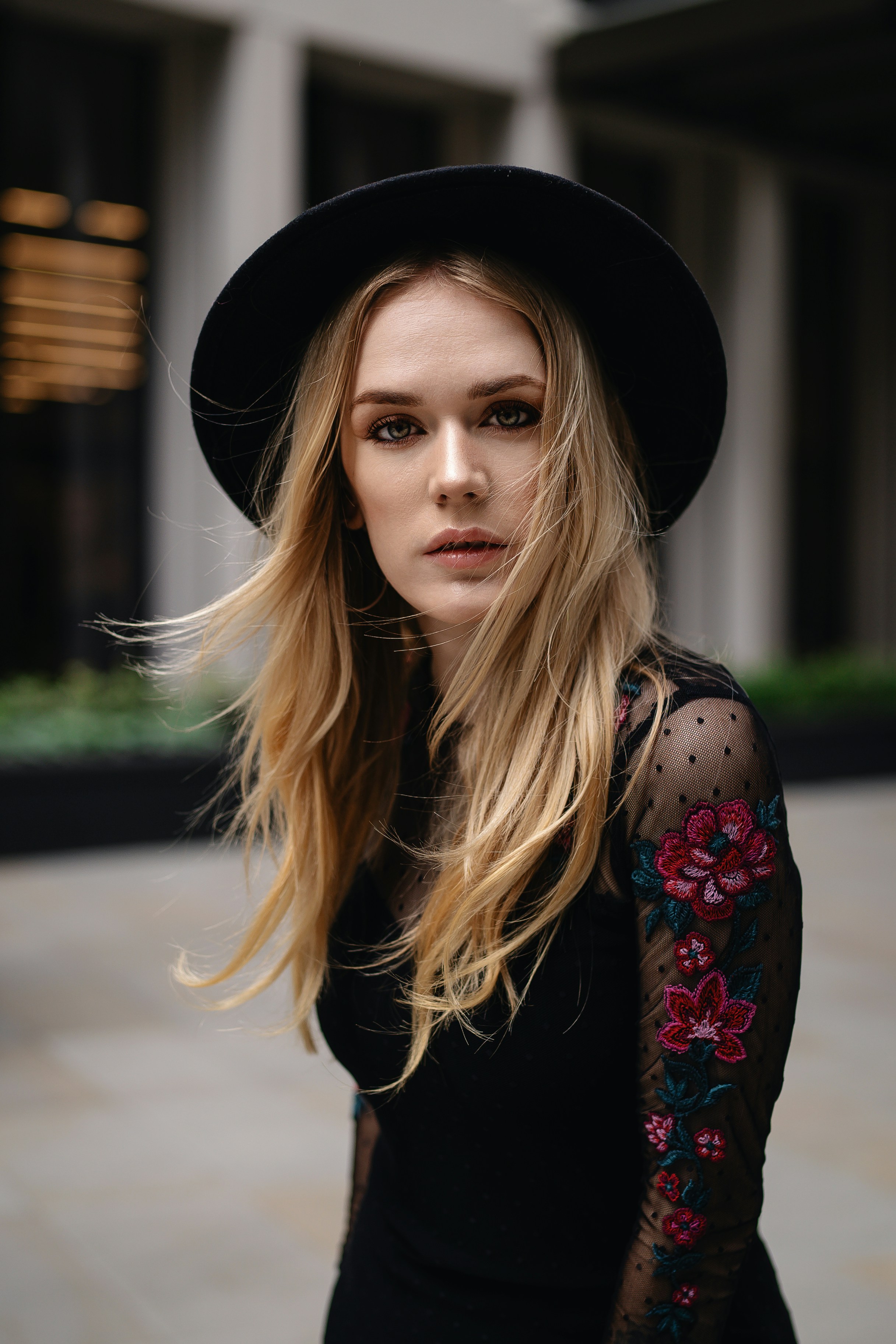 A woman wearing a black hat and a black dress