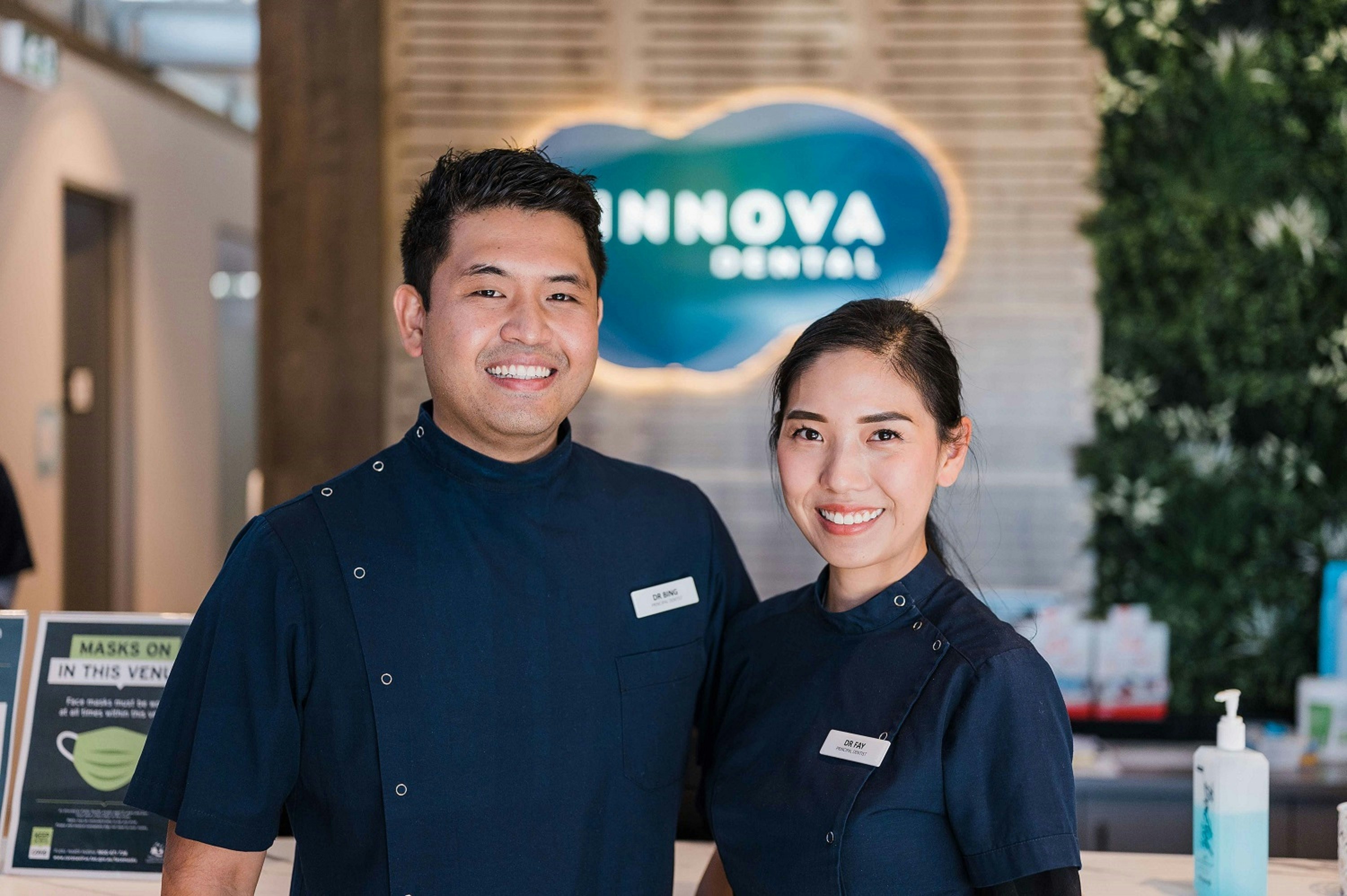 A man and a woman standing in front of a counter