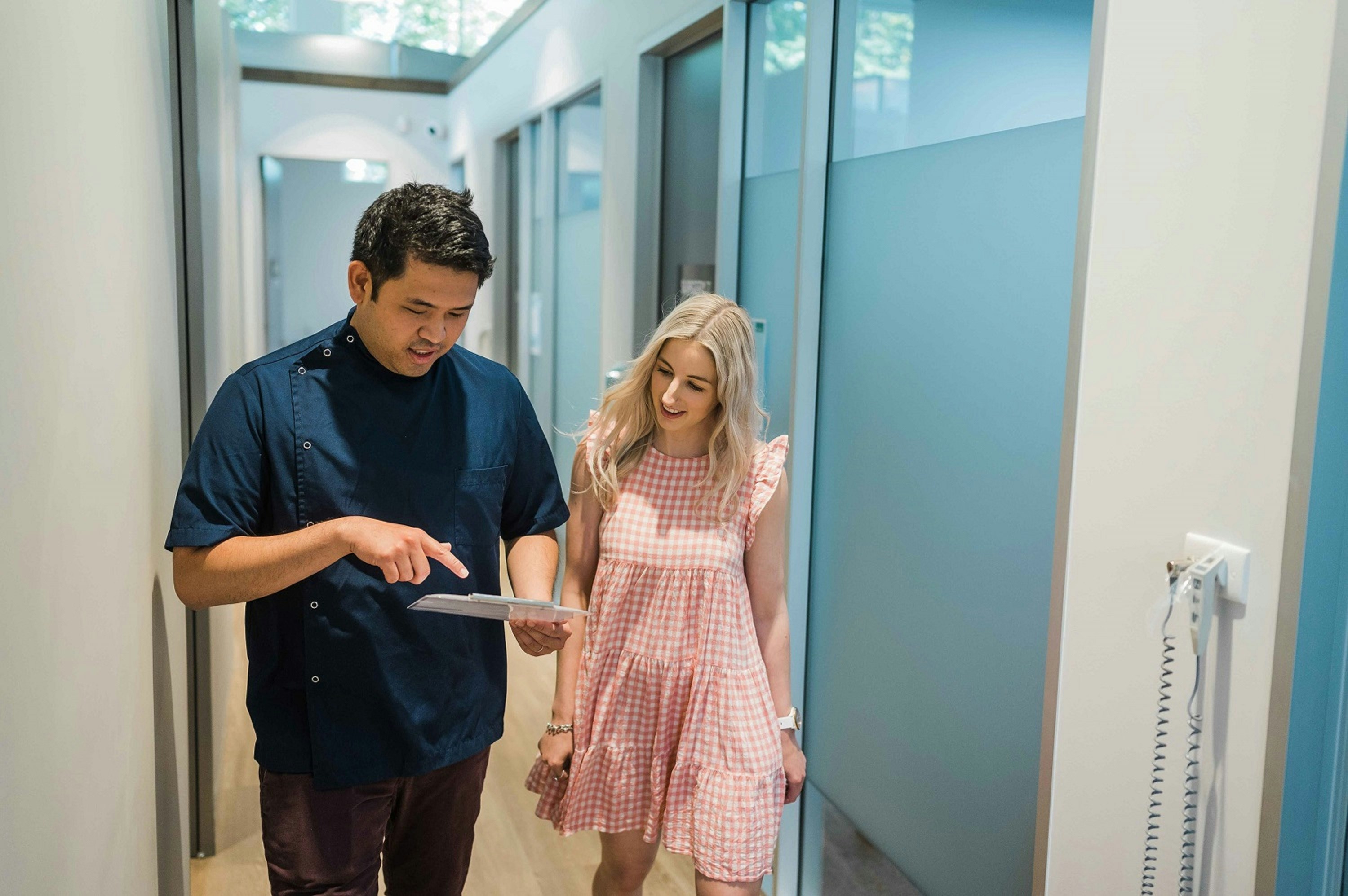 A man standing next to a woman in a hallway