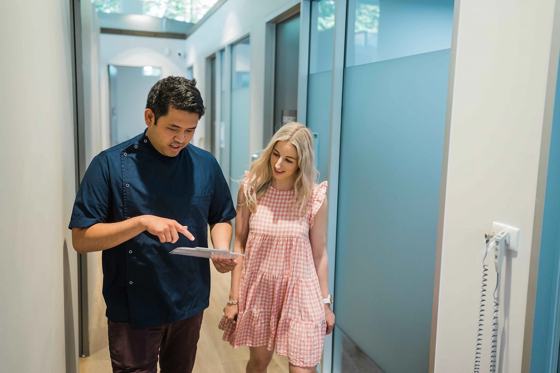 Healthcare provider assisting a patient during walking rehabilitation