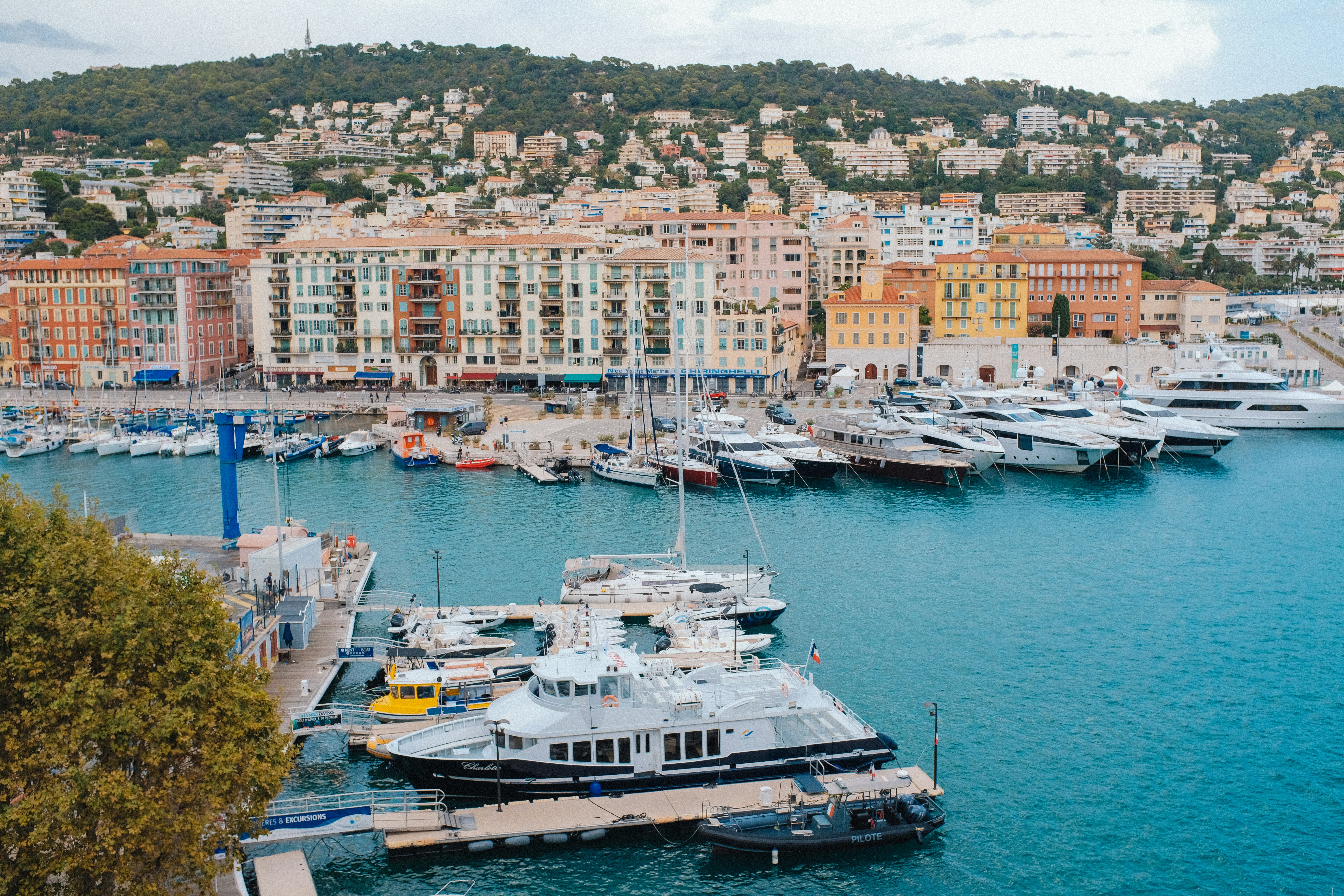 A harbor filled with lots of boats next to a city