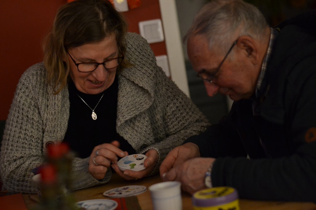 senior and caregiver working together on a puzzle at a kitchen table - elderly care pittsburgh senior and caregiver working together on a puzzle at a kitchen table - elderly care pittsburgh