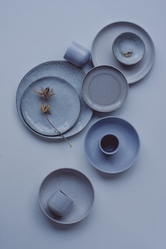 A white table topped with plates and cups