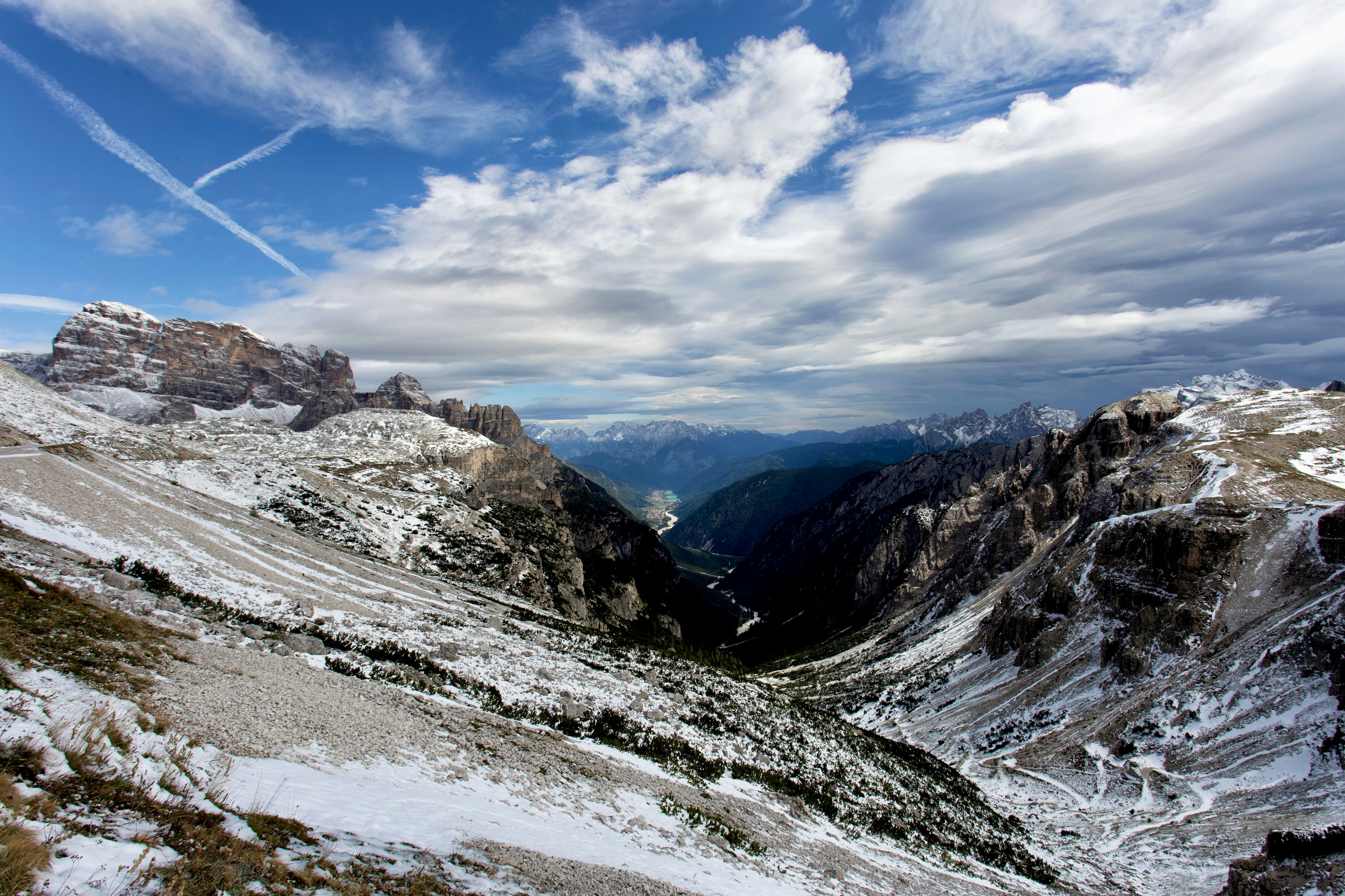 A snow covered mountain with a sky filled with clouds