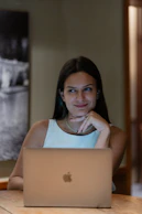 A woman sitting in front of a laptop computer