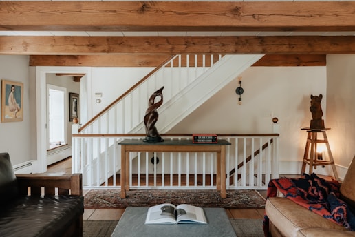 A living room filled with furniture and a staircase